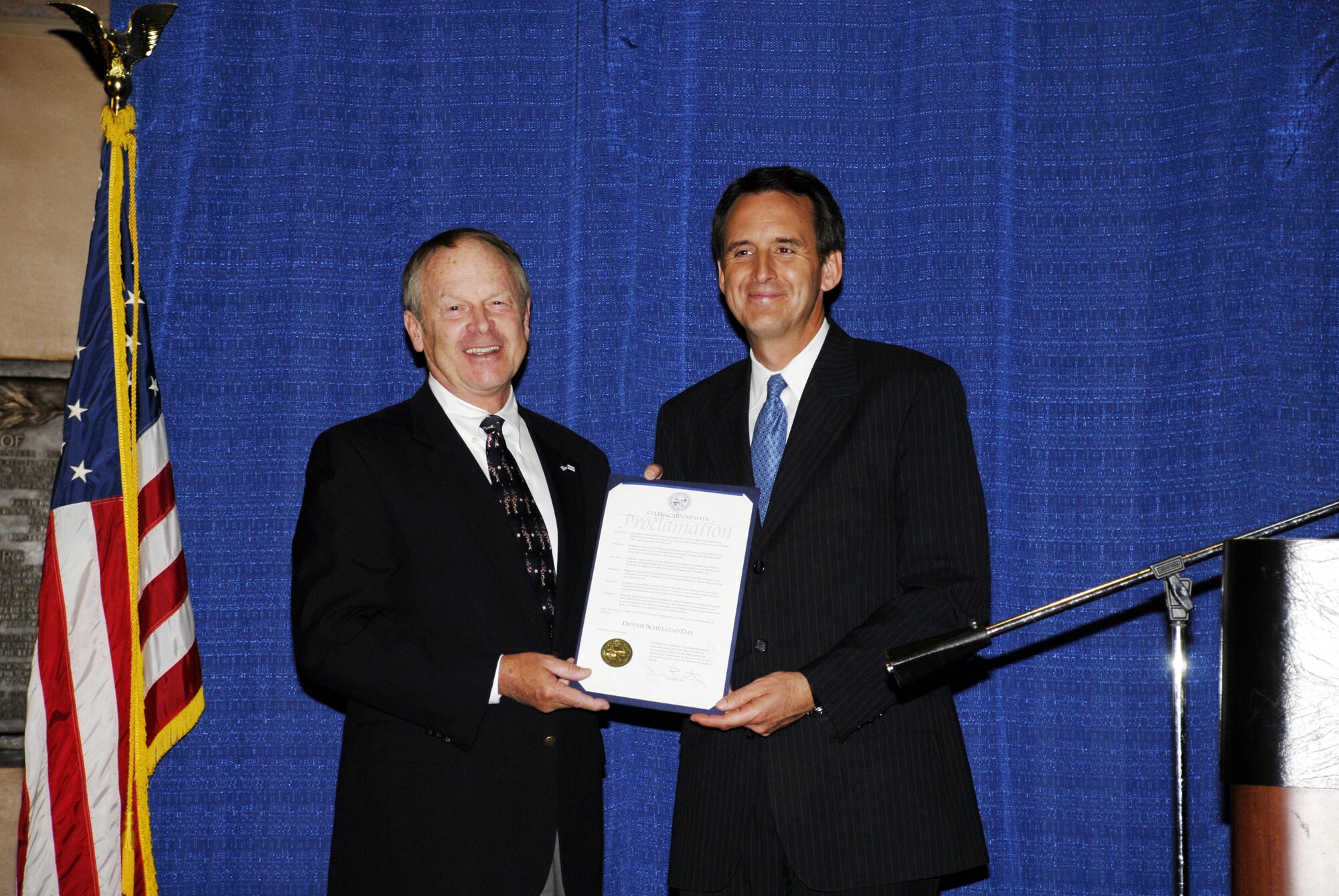Governor Tim Pawlenty (right) presents retired Air Force Brig. General and former 934th Airlift Wing member Denny Schulstad with a proclaimation at the state capitol declaring Sept. 15 as ?Denny Schulstad Day? in Minnesota.  This proclamation is in recognition of General Schulstad?s outstanding volunteer service to the men and women of the National Guard and Reserve through his work with Employer Support of the Guard and Reserve.  Governor Pawlenty also awarded the Secretary of Defense Medal for Outstanding Public Service to the General and proclaimed the week of September 15-19 to be ?Employer Support of the Guard and Reserve Week? in the State.   (Air Force photo/Master Sgt. Paul Zadach) 