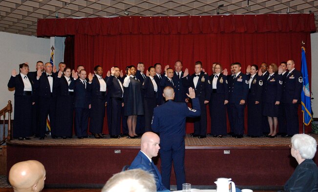 FAIRCHILD AIR FORCE BASE, Wash. –Tech. Sgt. Ronnie Flores, non-commissioned officer in charge of Military Justice, walks through the cordon with his mother Rebecca Vogel and wife Veronica Flores during the Senior NCO Induction Ceremony at Club Fairchild Sept. 25. Over thirty promotees were recognized by family and friends. (Air Force photo / Airman 1st Class Melissa Barnett)