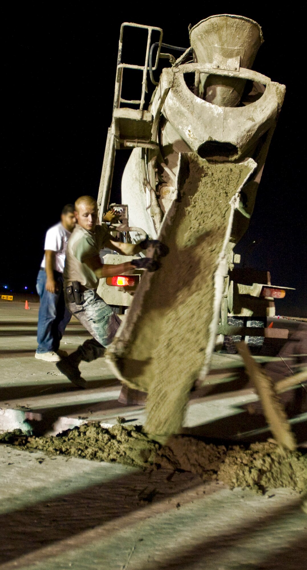 Senior Airman Ian Newkirk moves cement to evenly fill holes on a taxiway Sept. 22 at Ali Base, Iraq. Extreme heat, along with normal wear and tear, can damage portions of the flightline, making it unsafe for aircraft. Airman Newkirk, a pavements and construction equipment apprentice with the 407th Expeditionary Civil Engineer Squadron, is deployed from Malmstrom Air Force Base, Mont. (U.S. Air Force photo/Airman 1st Class Christopher Griffin) 
