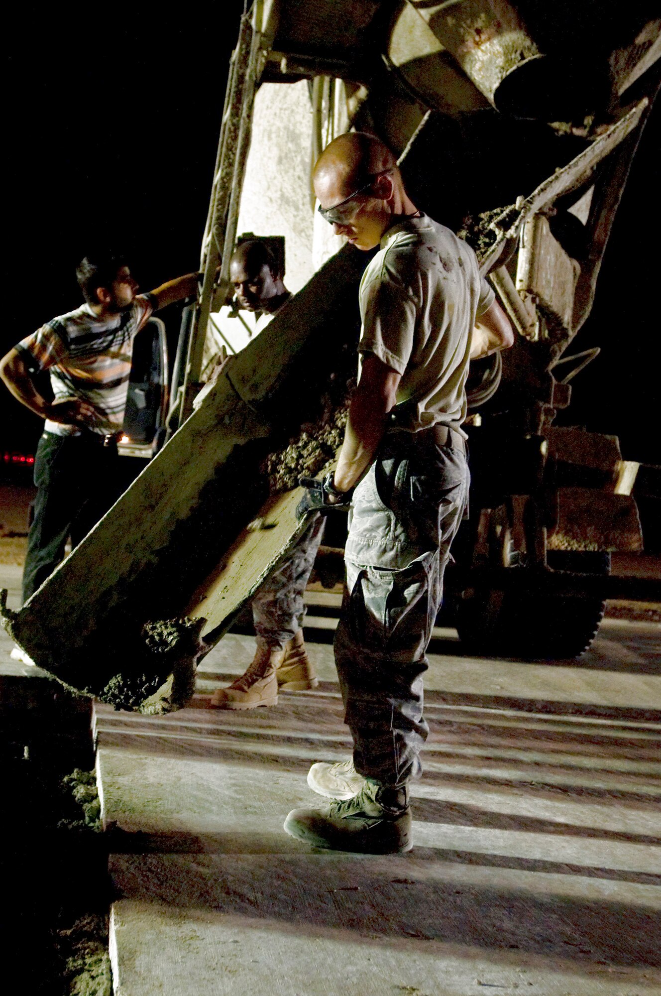 Senior Airman Ian Newkirk moves cement to evenly fill holes on a taxiway Sept. 22 at Ali Base, Iraq. Extreme heat, along with normal wear and tear, can cause cracks or potholes to form, making portions of the flightline unsafe for aircraft. Airman Newkirk, a pavements and construction equipment apprentice with the 407th Expeditionary Civil Engineer Squadron, is deployed from Malmstrom Air Force Base, Mont. (U.S. Air Force photo/Airman 1st Class Christopher Griffin) 

