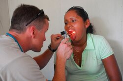Army Maj. Robert Price, Joint Task Force-Bravo Medical Element, checks a patient who is experiencing a sore throat during a medical readiness exercise Sept. 25 in La Pena, Costa Rica. (U.S. Air Force photo by Staff Sgt. Joel Mease)