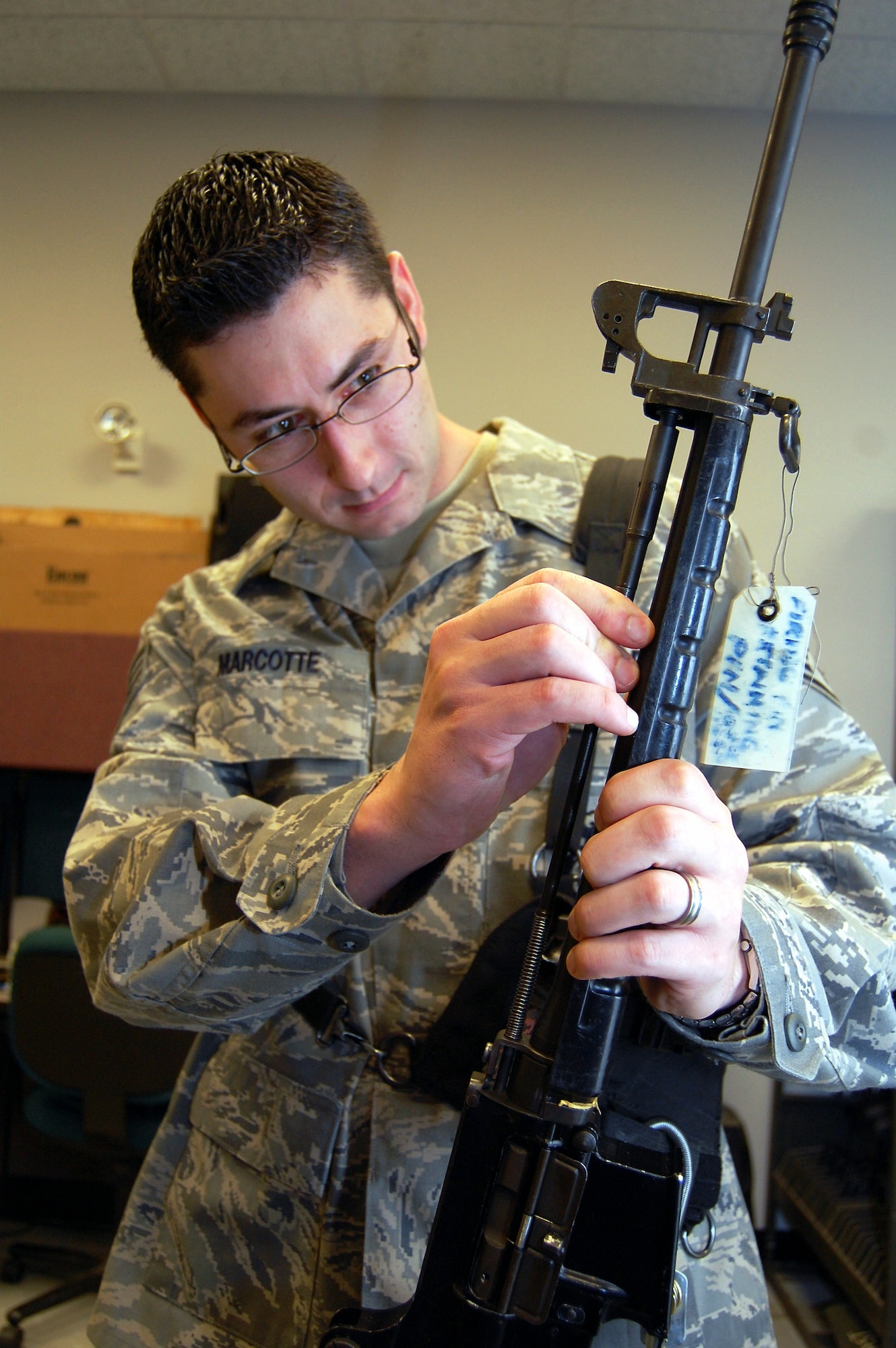 Staff Sgt. Ryan Marcotte inspects the forward assembly of a T-65 rifle while working in the armory Sept. 22 at Fort Dix, N.J. Sergeant Marcotte is the Air Force Expeditionary Center armory combat arms instructor. He and three other Airmen manage 48 different weapons systems and 153 different types of foreign weapons in their armory -- the most foreign weapons than any armory in the Air Force. The weapons they care for support more than 7,000 students annually who attend the center's expeditionary courses. (U.S. Air Force photo/Tech. Sgt. Scott T. Sturkol)
