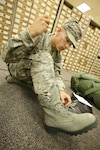 09/10/2008 - Basic military trainee Benjamin Stanley, 321st Training Squadron, laces up his newly issued sage boots. The sage boots, part of the new Airman's Battle Uniform, were issued to BMT trainees for the first time Sept. 8. (USAF photo by Robbin Cresswell)  