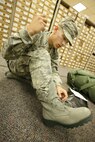 09/10/2008 - Basic military trainee Benjamin Stanley, 321st Training Squadron, laces up his newly issued sage boots. The sage boots, part of the new Airman's Battle Uniform, were issued to BMT trainees for the first time Sept. 8. (USAF photo by Robbin Cresswell)  