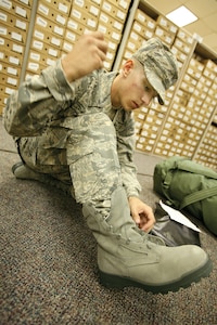 09/10/2008 - Basic military trainee Benjamin Stanley, 321st Training Squadron, laces up his newly issued sage boots. The sage boots, part of the new Airman's Battle Uniform, were issued to BMT trainees for the first time Sept. 8. (USAF photo by Robbin Cresswell)  