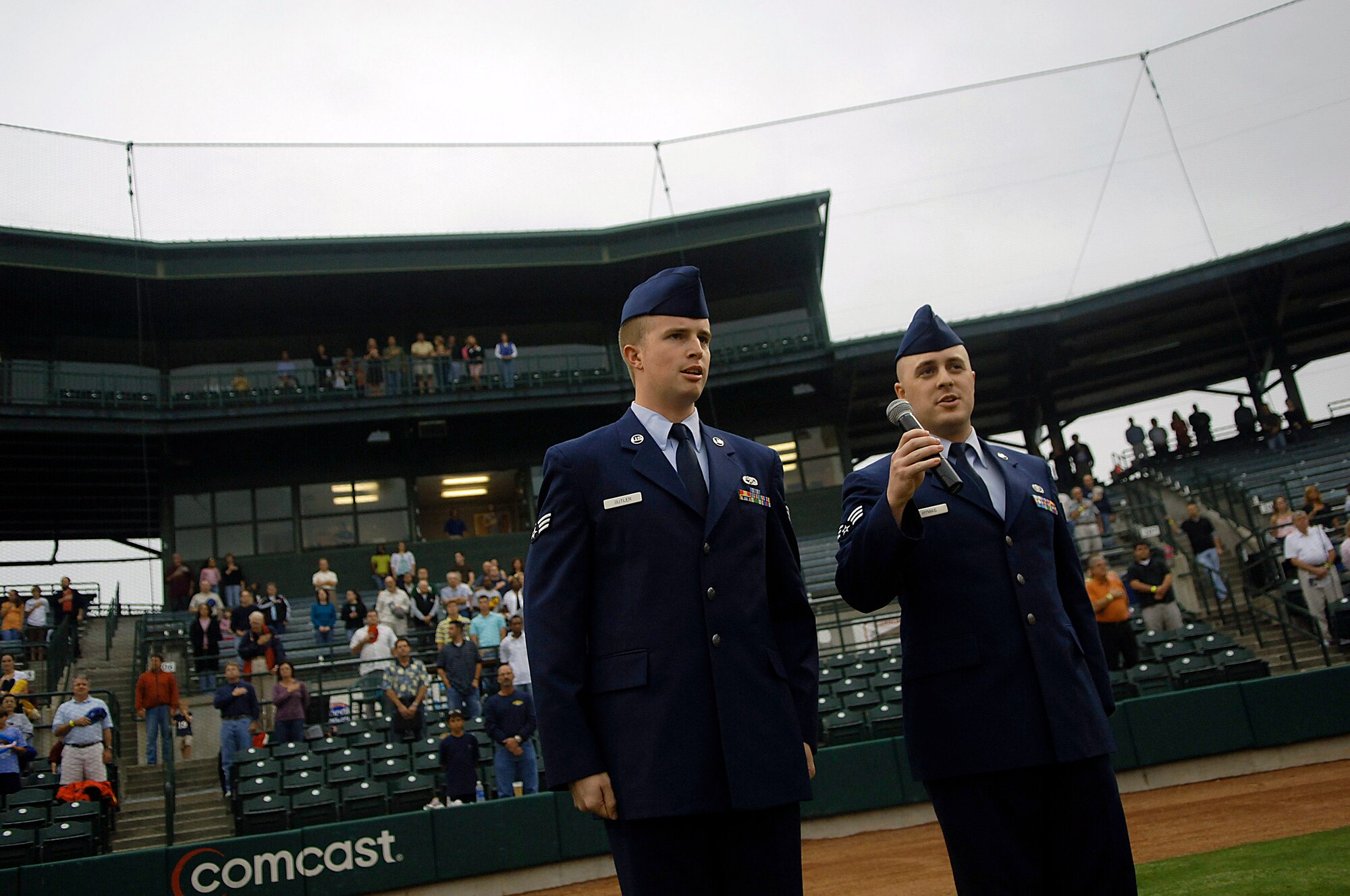Senior Airman Kris Butler and Staff Sgt. (then senior airman) Sam Hymas sing the national anthem to open the Charleston Riverdogs game May 29 at Joseph P. Riley Jr. Park in Charleston, S.C. Airman Butler is with the 437th Aircraft Maintenance Squadron and Airman Hymas is assigned to the 437th Airlift Wing. (U.S. Air Force photo/Senior Airman Nicholas Pilch)