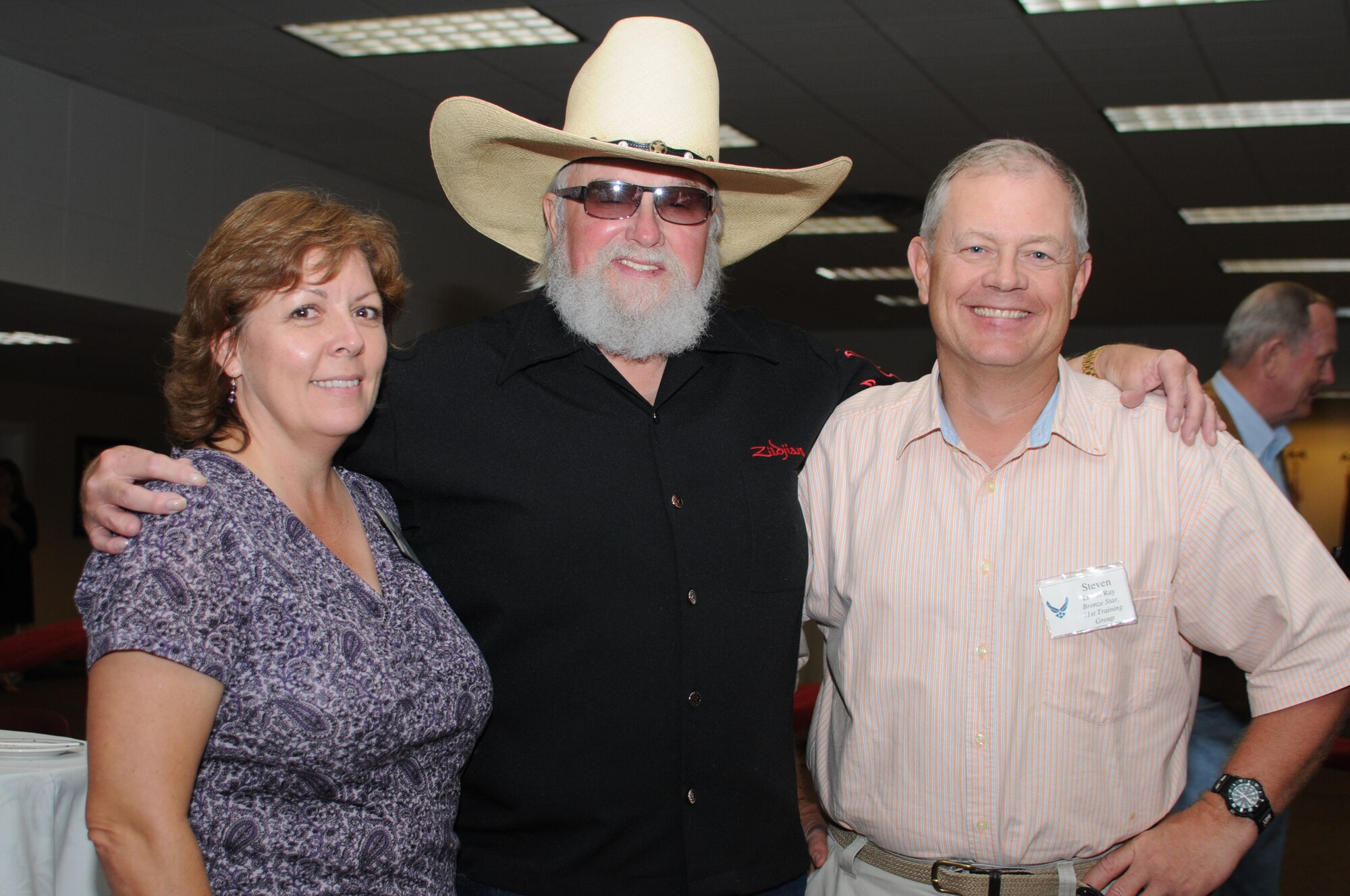 Karen and Lt. Col. Stephen Ray, 81 Training Group, pose for a photo with Charlie Daniels at a pre-concert reception where Mr. Daniels met with base leadership, local community members and several Keesler Airmen who earned Bronze Stars for their actions in Iraq.  The Charlie Daniels Band performed for Keesler Air Force Base Airmen, families and local community members Sept. 18 to help celebrate the Air Force's 61st birthday.  (U.S. Air Force photo by Kemberly Groue)

