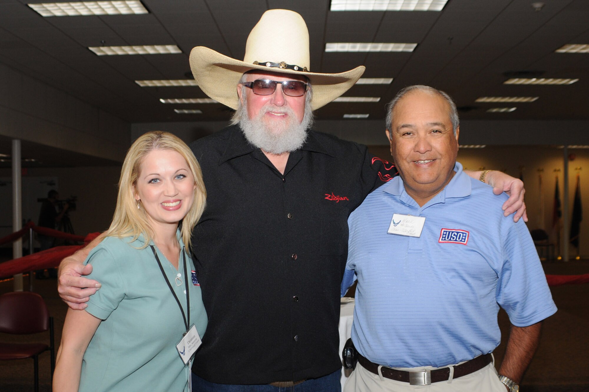 Deanna Attaway and Hank Saleido, USO representatives, pose for a photo with Charlie Daniels at a pre-concert reception where Mr. Daniels met with base leadership, local community members and several Keesler Airmen who earned Bronze Stars for their actions in Iraq.  The Charlie Daniels Band performed for Keesler Air Force Base Airmen, families and local community members Sept. 18 to help celebrate the Air Force's 61st birthday.  (U.S. Air Force photo by Kemberly Groue)

