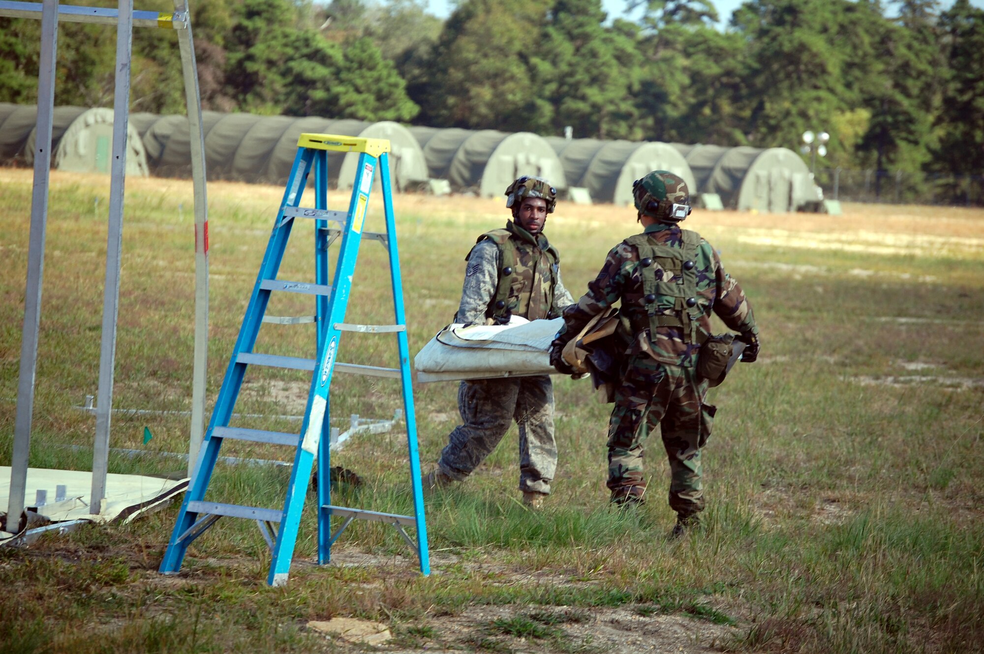 Students in Air Force Exercise Eagle Flag 08-6 carry framework for a tent as part of exercise operations Sept. 20, 2008, at Naval Air Engineering Station Lakehurst, N.J.  Eagle Flag is managed by the U.S. Air Force Expeditionary Center's 421st Combat Training Squadron at Fort Dix, N.J., and tests and trains Airmen in expeditionary combat support skills.  (U.S. Air Force Photo/Tech. Sgt. Scott T. Sturkol)