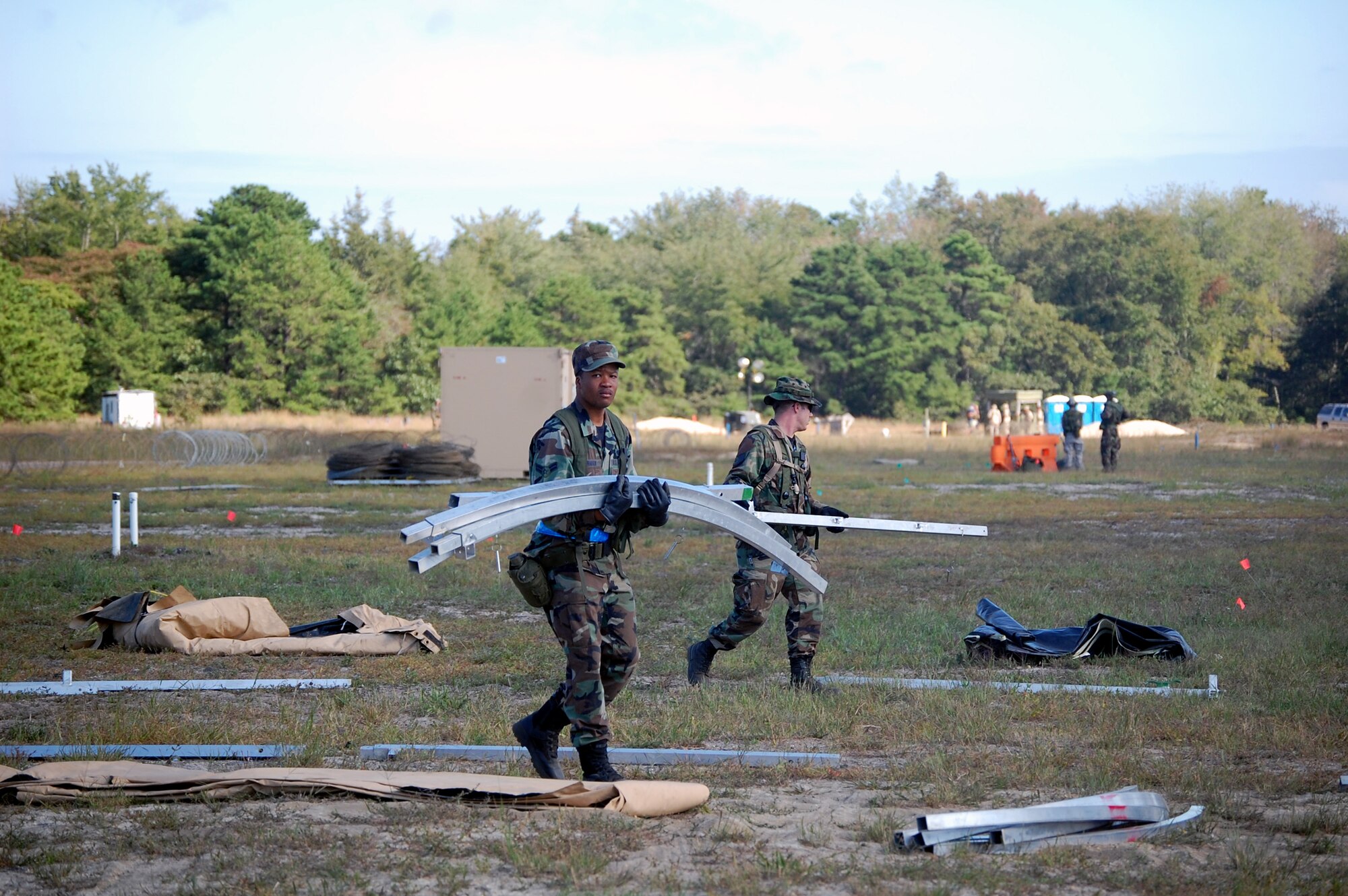Students in Air Force Exercise Eagle Flag 08-6 carry framework for a tent as part of exercise operations Sept. 20, 2008, at Naval Air Engineering Station Lakehurst, N.J.  Eagle Flag is managed by the U.S. Air Force Expeditionary Center's 421st Combat Training Squadron at Fort Dix, N.J., and tests and trains Airmen in expeditionary combat support skills.  (U.S. Air Force Photo/Tech. Sgt. Scott T. Sturkol)