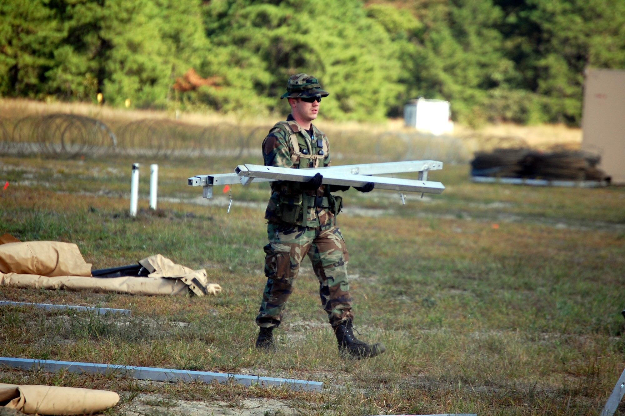A student in Air Force Exercise Eagle Flag 08-6 carries framework for a tent as part of exercise operations Sept. 20, 2008, at Naval Air Engineering Station Lakehurst, N.J.  Eagle Flag is managed by the U.S. Air Force Expeditionary Center's 421st Combat Training Squadron at Fort Dix, N.J., and tests and trains Airmen in expeditionary combat support skills.  (U.S. Air Force Photo/Tech. Sgt. Scott T. Sturkol)