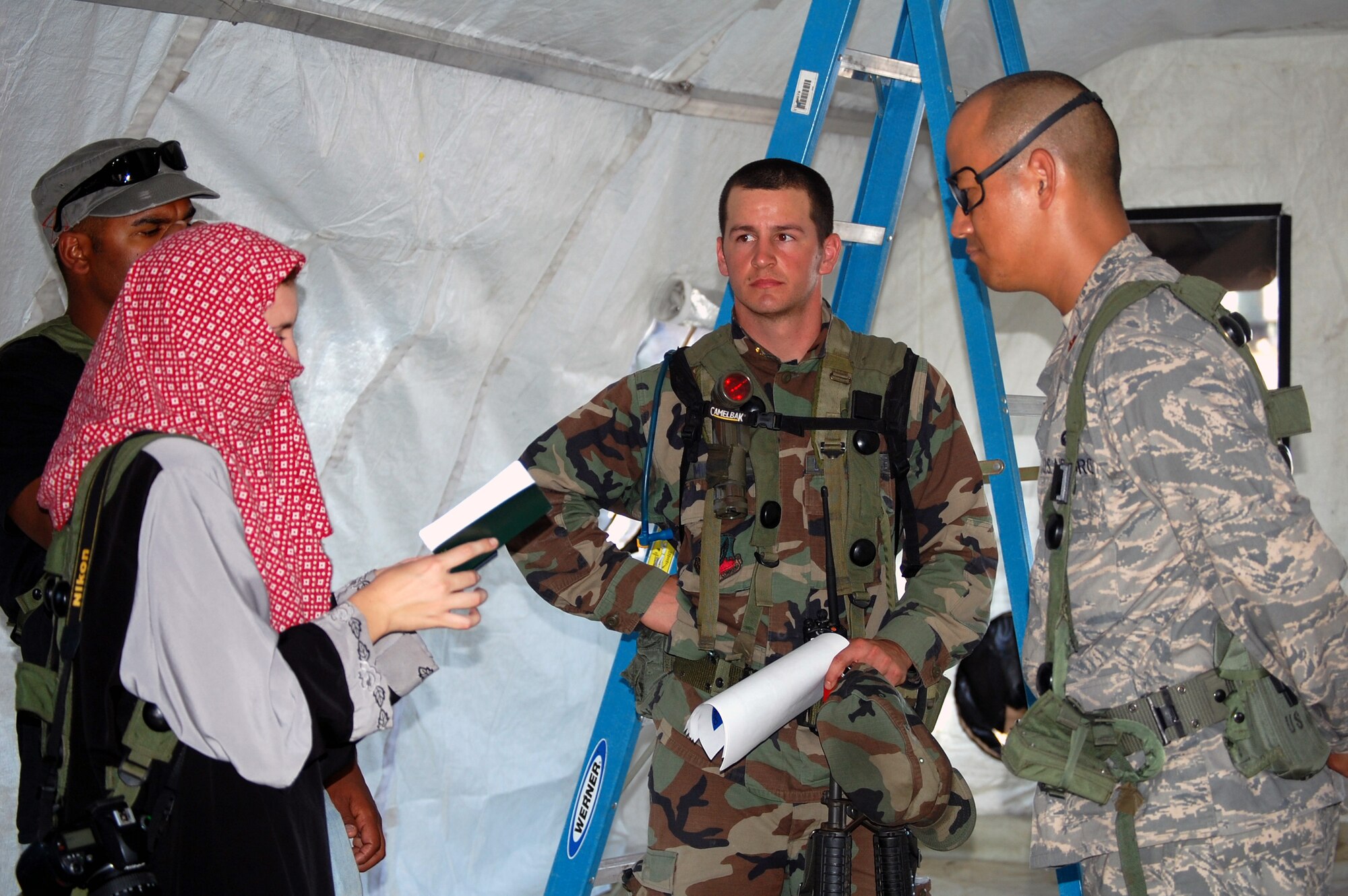 Maj. Young Han (right), from Maxwell Air Force Base, Ala., and a student in Air Force Exercise Eagle Flag 08-6, conducts a media interview during a scenario for Eagle Flag at Naval Air Engineering Station Lakehurst, N.J., Sept. 20, 2008.  Eagle Flag, managed by the U.S. Air Force Expeditionary Center's 421st Combat Training Squadron at Fort Dix, N.J., tests and trains Airmen in expeditionary combat support skills.  (U.S. Air Force Photo/Tech. Sgt. Scott T. Sturkol)