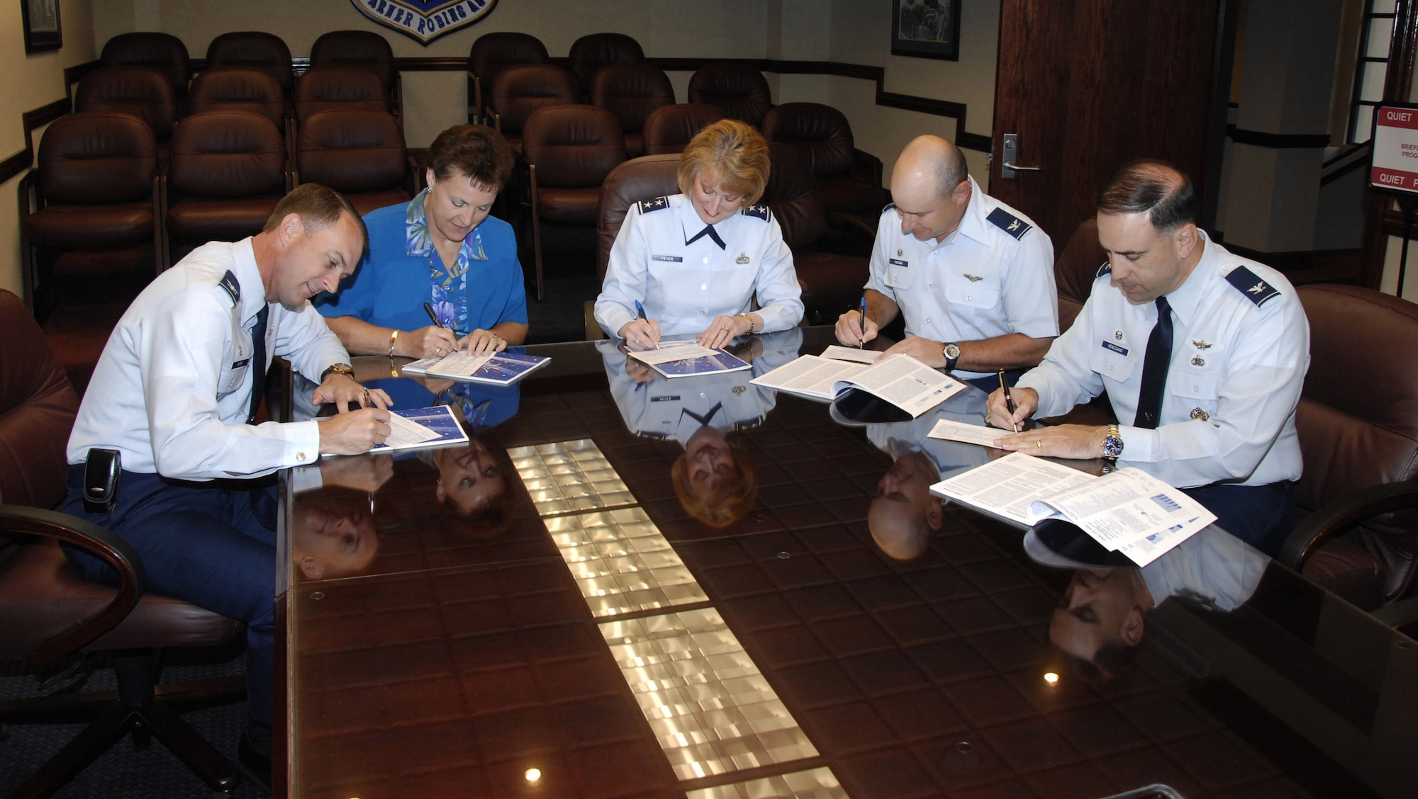 Members of Robins leadership sign their Combined Federal Campaign pledge cards. From left to right, Col. Warren Berry, 78th Air Base Wing Commander, Brenda Romine, Warner Robins Air Logistics Center executive director, Maj. Gen. Polly Peyer, WR-ALC commander, Col. Tim Freeman, 330th Aircraft Sustainment Wing commander, and Col. Joseph Veneziano, 542nd Combat Sustainment Wing commander. U. S. Air Force photo by Claude Lazzara
