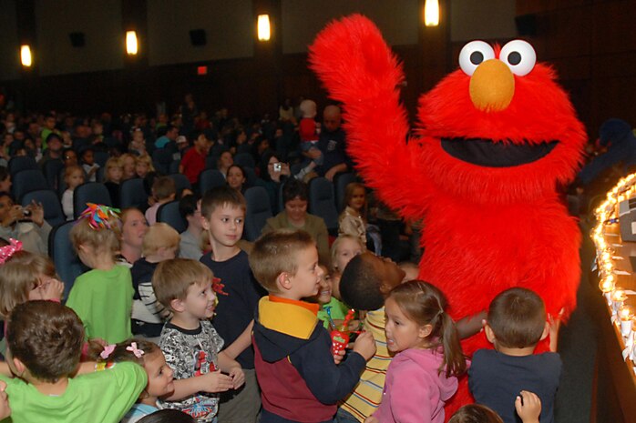 Elmo interacts with Team Charleston children during "The Sesame Street Experience" at the base theater Sept. 25. The initiative of this United Service Organizations program is to provide support and offer resources for military families with young children experiencing the effects of deployment, multiple deployments or when a parent returns home changed due to a combat-related injury. (U. S. Air Force photo/Airman 1st Class Melissa White)