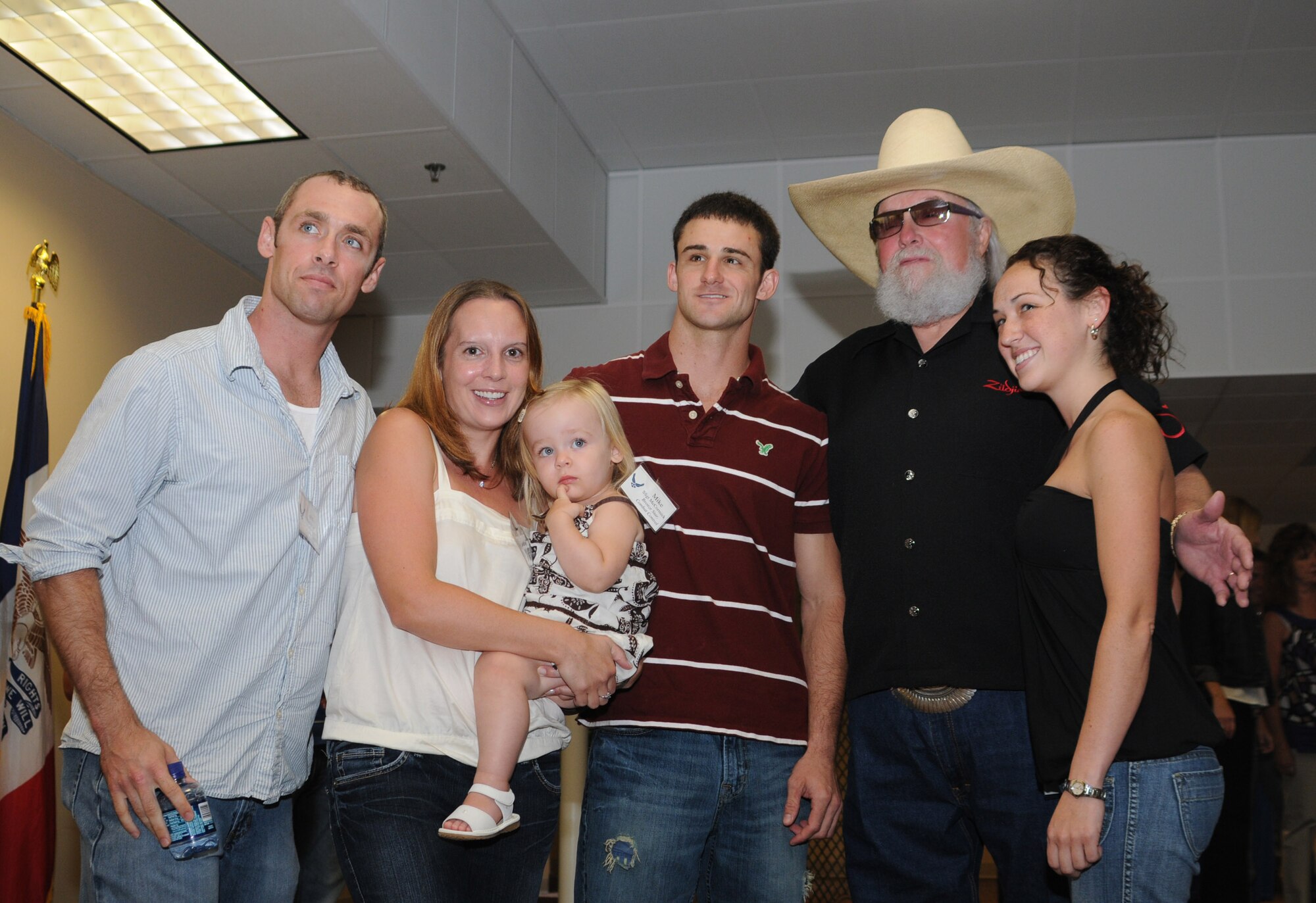 Airmen and their spouses pose for a photo with Charlie Daniels at a pre-concert reception where Mr. Daniels met with base leadership, local community members and several Keesler Airmen who earned Bronze Stars for their actions in Iraq.  The Charlie Daniels Band performed for Keesler Air Force Base Airmen, families and local community members Sept. 18 to help celebrate the Air Force's 61st birthday.  (U.S. Air Force photo by Kemberly Groue)