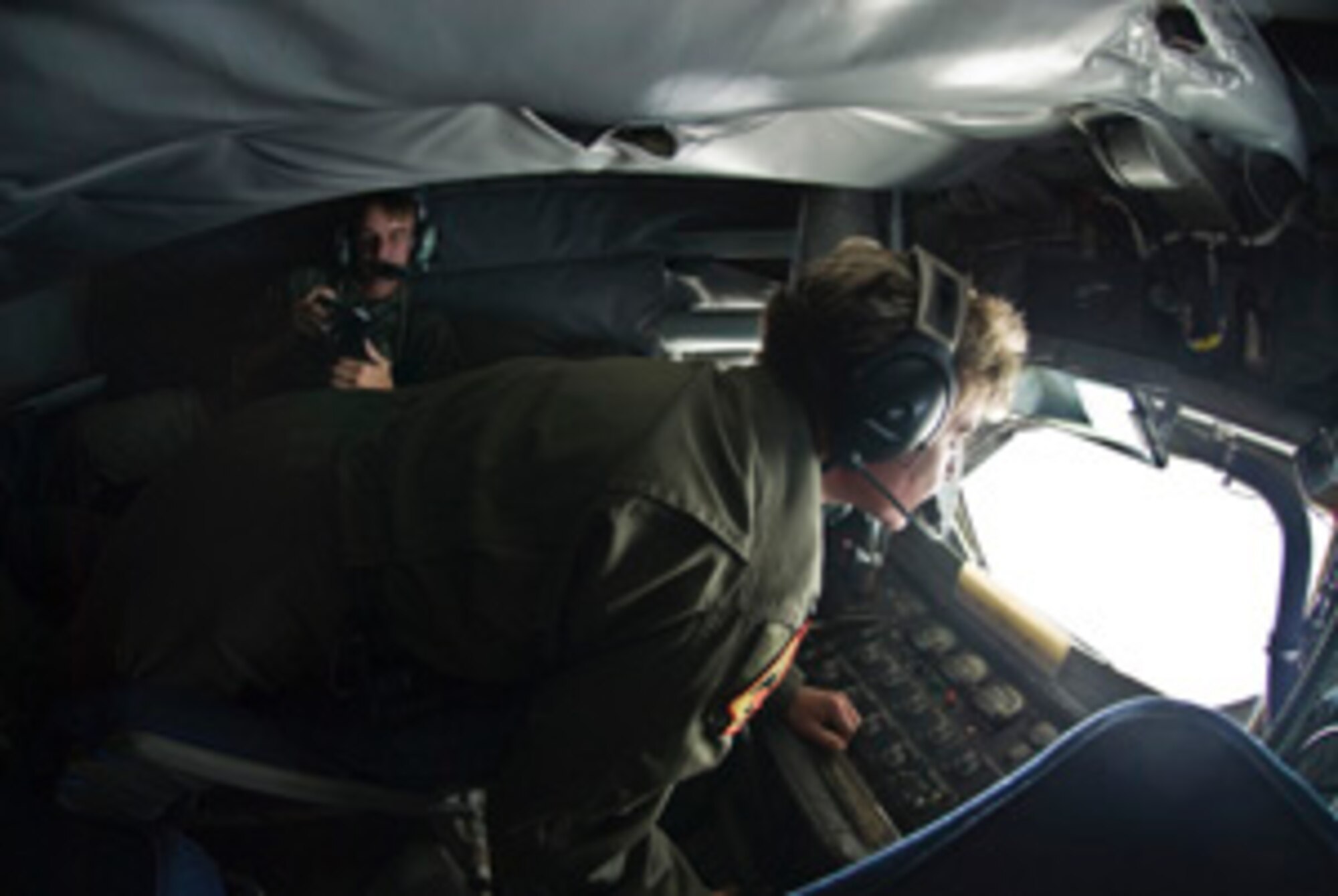 PACIFIC OCEAN (July 23, 2008) – 
Mass Communication Specialist 1st Class (AW/NAC) Dan Woods, assigned to Fleet Combat Camera Group Pacific, documents Tech Sergeant Kelly Witt, a boom operator assigned to the 465th Air Refueling Squadron, refuels CF-18's of the Canadian Defence Force's 409 Tactical Fighter Squadron during Exercise Rim of the Pacific 2008.  RIMPAC, the world’s largest multinational exercise, is scheduled biennially by U.S. Pacific Fleet and takes place in the Hawaiian operating area during 29 June - 31 July 2008.  Participants include Australia, Canada, Chile, Japan, Netherlands, Peru, Republic of Korea, Singapore, United Kingdom and the U.S.    U S Navy photo by Mass Communications Specialist 2nd Class (AW/NAC) Scott Taylor. (Released)