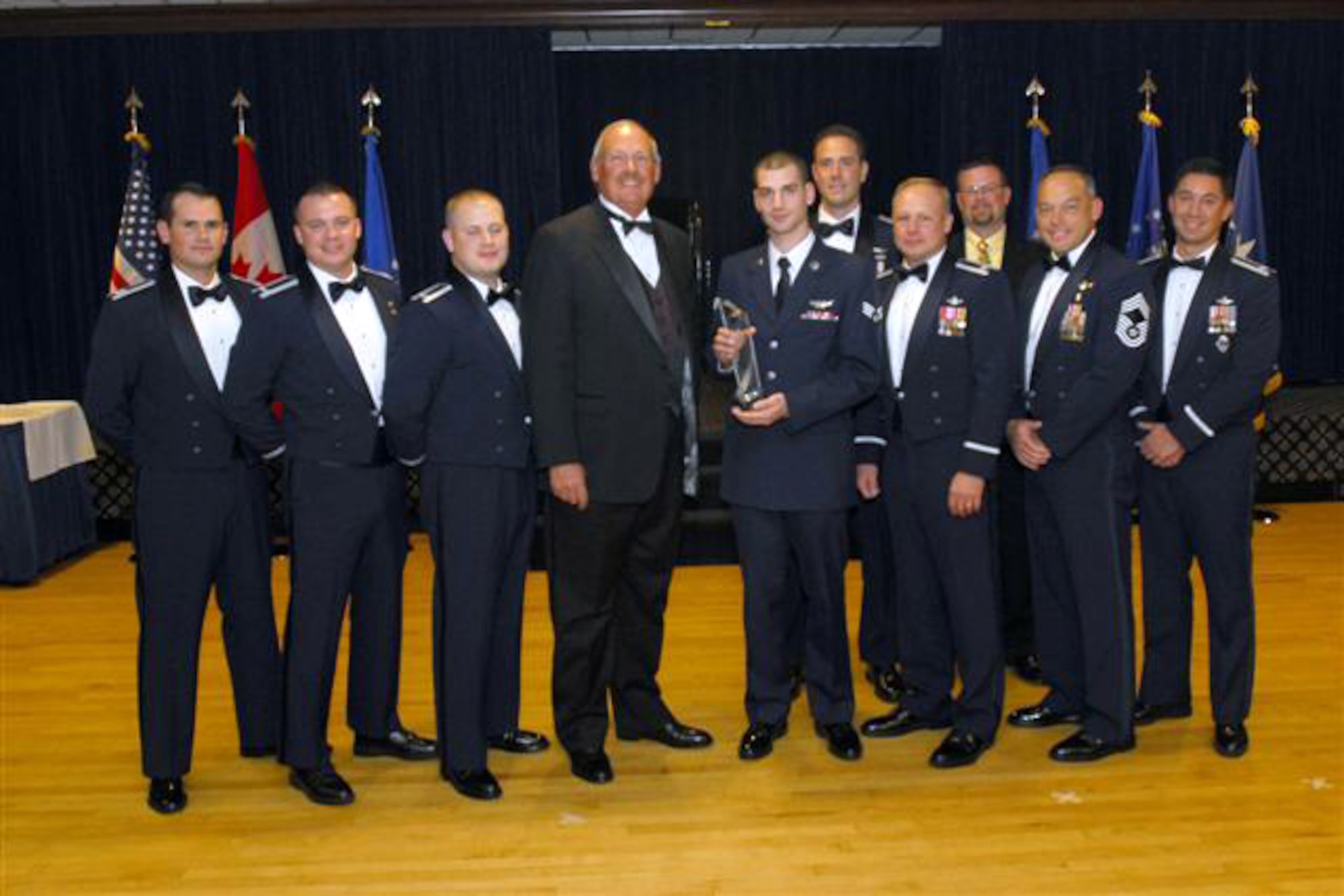 EGLIN AIR FORCE BASE, Fla. -- (from left to right) Capt. Zach Sartin; 1st Lt Mike Wilson; 1st Lt. Keith Harrigan; Retired Gen. Lance Lord; Senior Airman Mark Tomasetti; Col. Chris Crawford, 21st OG/CC; Chief Master Sgt. Randy Lacombe, 21st  OG; Lt. Col. Steve Buzon, Det 1 CC; Lt. Col. Thomas Falzarano; Scott Leonard, Civilian Lord Award winner from Det 1. (Courtesy Photo)