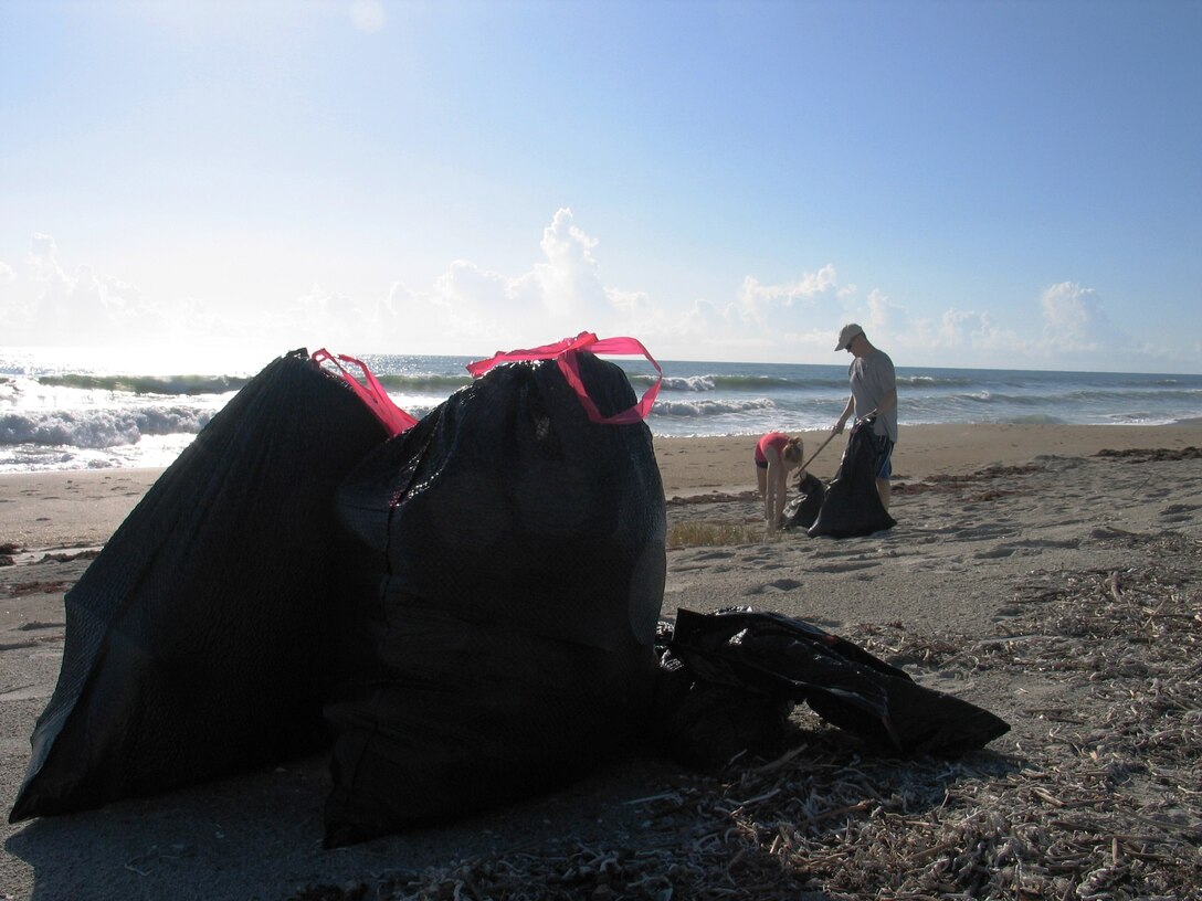 Lt. Col. Patrick Youngson, Operations Officer, 45th Operations Support Squadron is helped by his daughter Lauren, age 12, as they participate in the “Florida Coastal Cleanup”, held September 20. (U.S. Air Force photo by Airman 1st Class David Dobrydney)