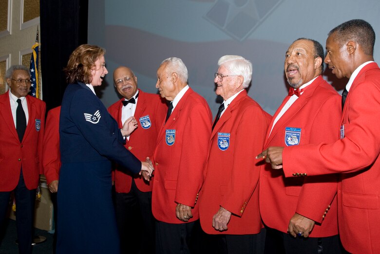 Staff Sgt. Jessica Rolfe of the 45th Medical Group, shakes hands with the Tuskegee Airmen who attended the 2008 Air Force Ball (U.S. Air Force photo by Jim Laviska)