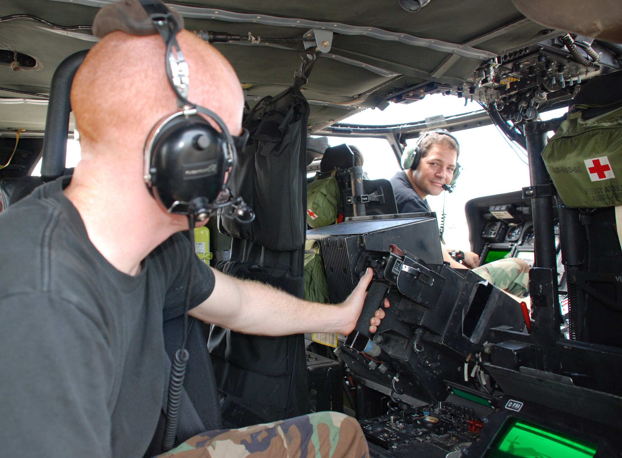 PATRICK AIR FORCE BASE, Fla. -- Air Force Reservists Staff Sgt. Kyle Cole (left) and Senior Airman John Fusco test the Forward Looking Infrared (FLIR) system on an HH-60G Pave Hawk helicopter. Unlike night vision technology, which relies on availible light to create an image, FLIR senses heat from any source -- personnel, vehicles, animals, etc. The system helps search-and-rescue pilots locate people in conditions such as fog, smoke or darkness, conditions that would normally make rescue work impossible. The 920th Rescue Wing provides combat search and rescue support during wartime, and also provides civilian search and rescue support, humanitarian relief and NASA launch support. (U.S. Air Force photo/Staff Sgt. Heather Kelly)