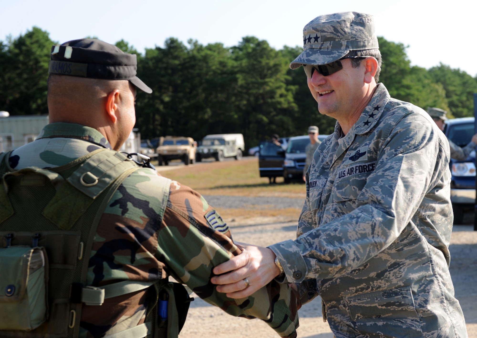 Tech. Sgt. Norman Ramos, from the U.S. Air Force Expeditionary Center's 421st Combat Training Squadron, greets Lt. Gen. Vern "Rusty" Findley, Air Mobility Command vice commander, while the general was touring operations for Air Force Exercise Eagle Flag 08-6 Sept. 23, 2008, at Naval Air Engineering Station Lakehurst, N.J.  General Findley visited the Expeditionary Center over two days from Sept. 22-23 to learn more about the unit's mission and capabilities.  (U.S. Air Force Photo/Staff Sgt. Nathan Bevier)