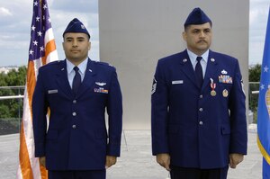 Master Sgt. Carlos Ramirez, an Air National Guard Readiness Center lead air transportation career field manager, right, stands at attention with his son, Capt. Daniel Ramirez, 1st Helicopter Squadron instructor pilot, near the Air Force Memorial honor guard Sept 19.  (USAF photo by Bobby Jones)