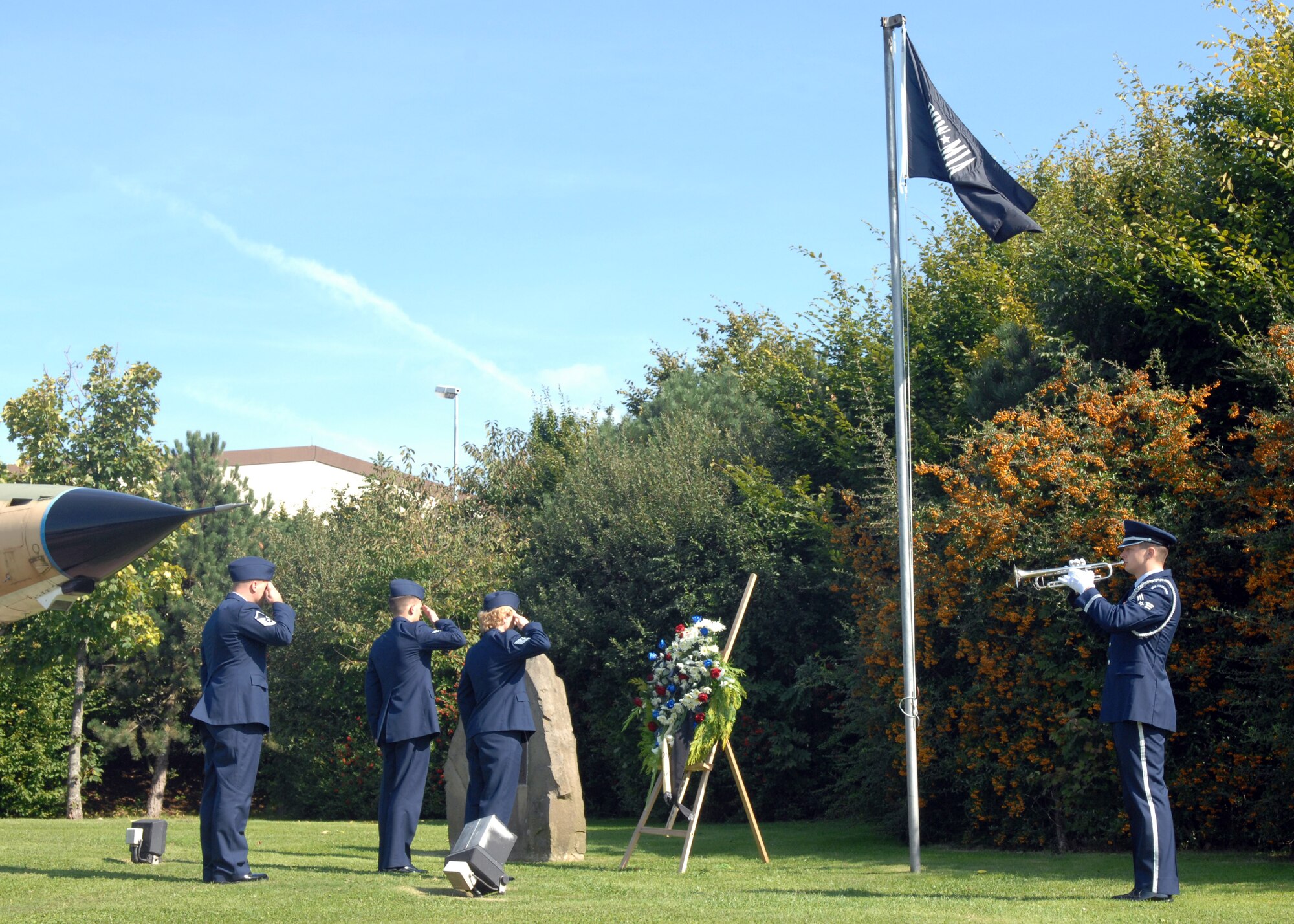 SPANGDAHLEM AIR BASE, Germany – Senior Airman Justin Lemmon, 52nd Equipment Maintenance Squadron, plays taps as (left to right) Master Sgt. Matthew Sabo, United States Air Forces in Europe 372nd Training Squadron, Detachment 17, Airman 1st Class Nathanael Callon, 52nd Fighter Wing Public Affairs, and Tech. Sgt Jamie Pivonka, USAFE 372nd TRS, Det. 17, salute during the Prisoners of War/Missing in Action Remembrance Ceremony Sept. 19, 2008. (U.S Air Force photo by Airman Staci Miller)