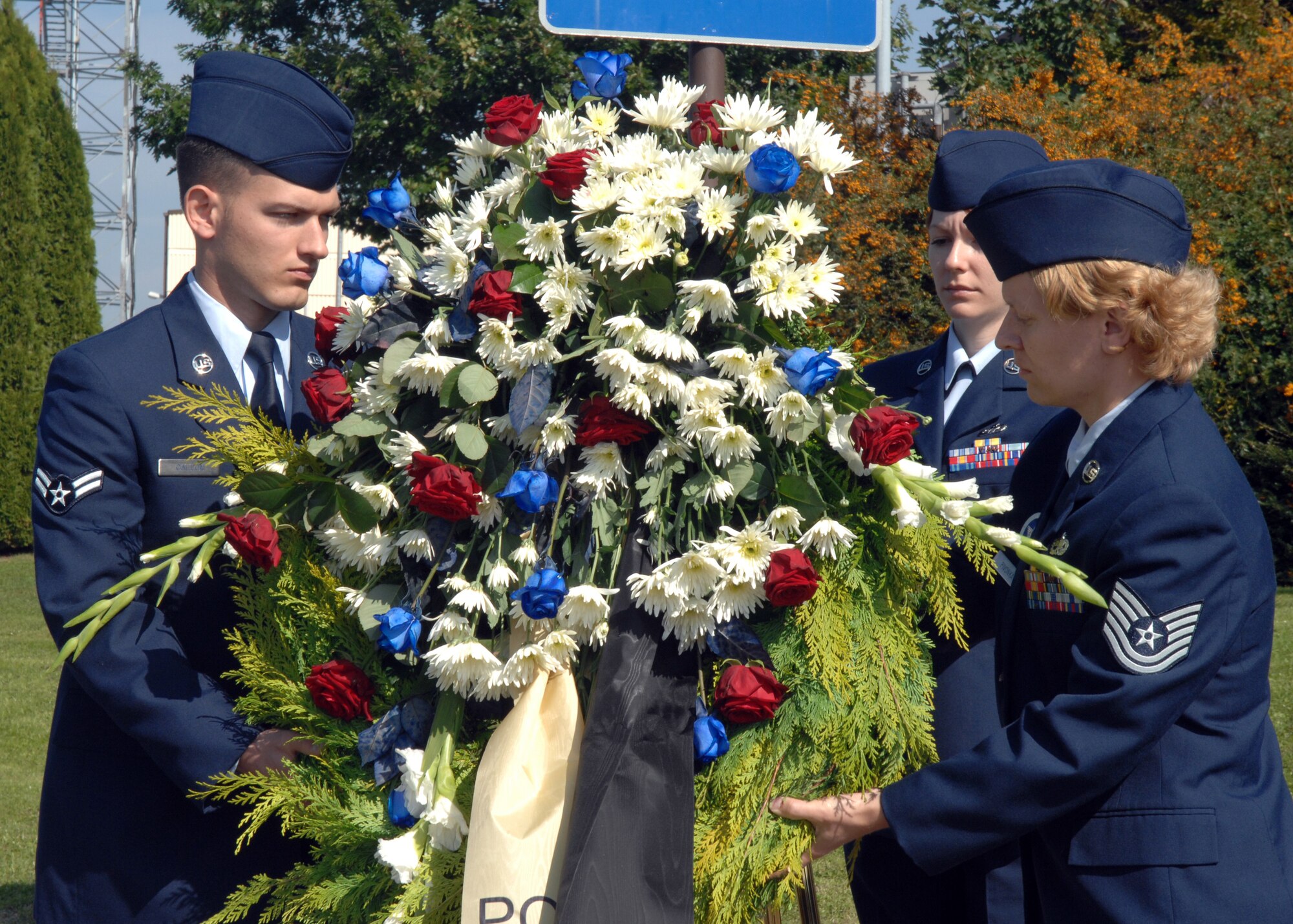 SPANGDAHLEM AIR BASE, Germany – Left to right, Airman 1st Class Nathanael Callon, 52nd Fighter Wing Public Affairs, Staff Sgt. Rebecca Sargent, 52nd Communications Squadron, and Tech. Sgt Jamie Pivonka, United States Air Forces in Europe 372nd Training Squadron, Detachment 17, carry a wreath in the POW/MIA Ceremony Sept. 19, 2008.  The Airmen placed the wreath at the prisoners of war/missing in action memorial in remembrance of all those who have fought for our country, and those who are listed as POW/MIA.  (U.S Air Force photo by Airman Staci Miller)