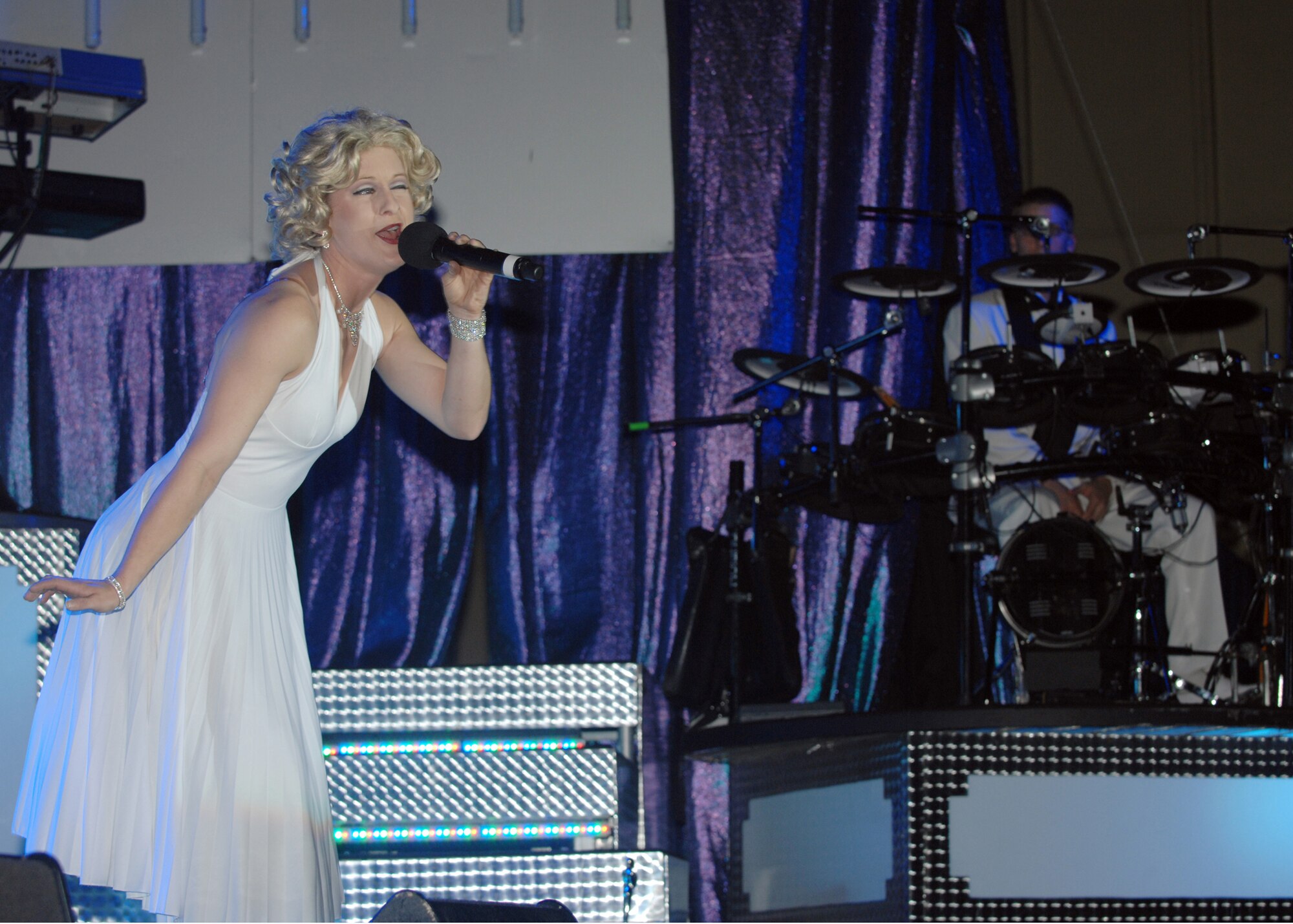 Senior Airman April Vollm, Tops in Blue comedian, performs a skit for the crowd at Incirlik Sept. 23. Airman Vollm portrayed Marilyn Monroe singing "Happy Birthday Mr. President." (U.S. Air Force photo by Staff Sgt. Jeff Nevison)