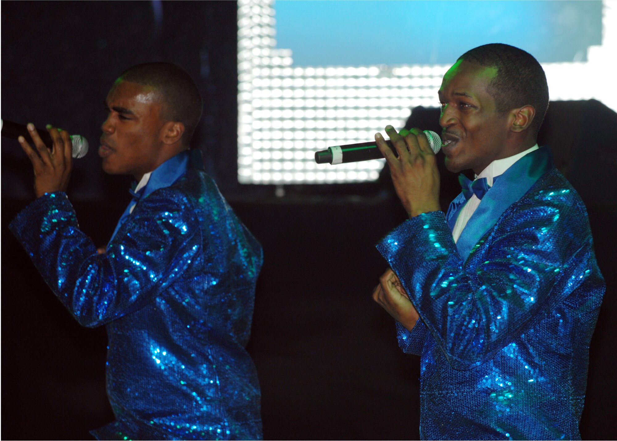 Airmen 1st Class Tommie Crutcher and Quentin Thomas perform a musical number during a Tops in Blue performance Sept. 23. This is Airmen Crutcher and Thomas' first year in Tops in Blue. (U.S. Air Force photo by Staff Sgt. Jeff Nevison)