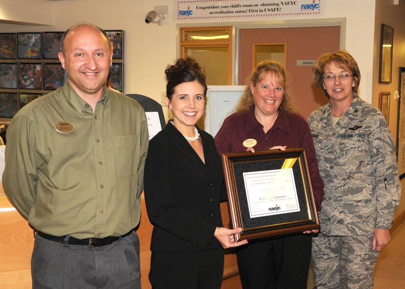 Col. Eden J. Murrie, 100th Air Refueling Wing commander, right, presents the “National Association for the Education of Young Children” certificate to (from left) Assistant Director Nick Batey, Director Krista Thomas, and Training Curriculum Specialist Dawn Tiger of the Child Development Center Sept. 25, 2008, at RAF Mildenhall, England. The CDC is the first in U.S. Air Forces in Europe to receive the accredited certificate. More than 50 staff members and 15 months of hard work contributed toward this crowning achievement. (U.S. Air Force photo by Staff Sgt. Jerry Fleshman)