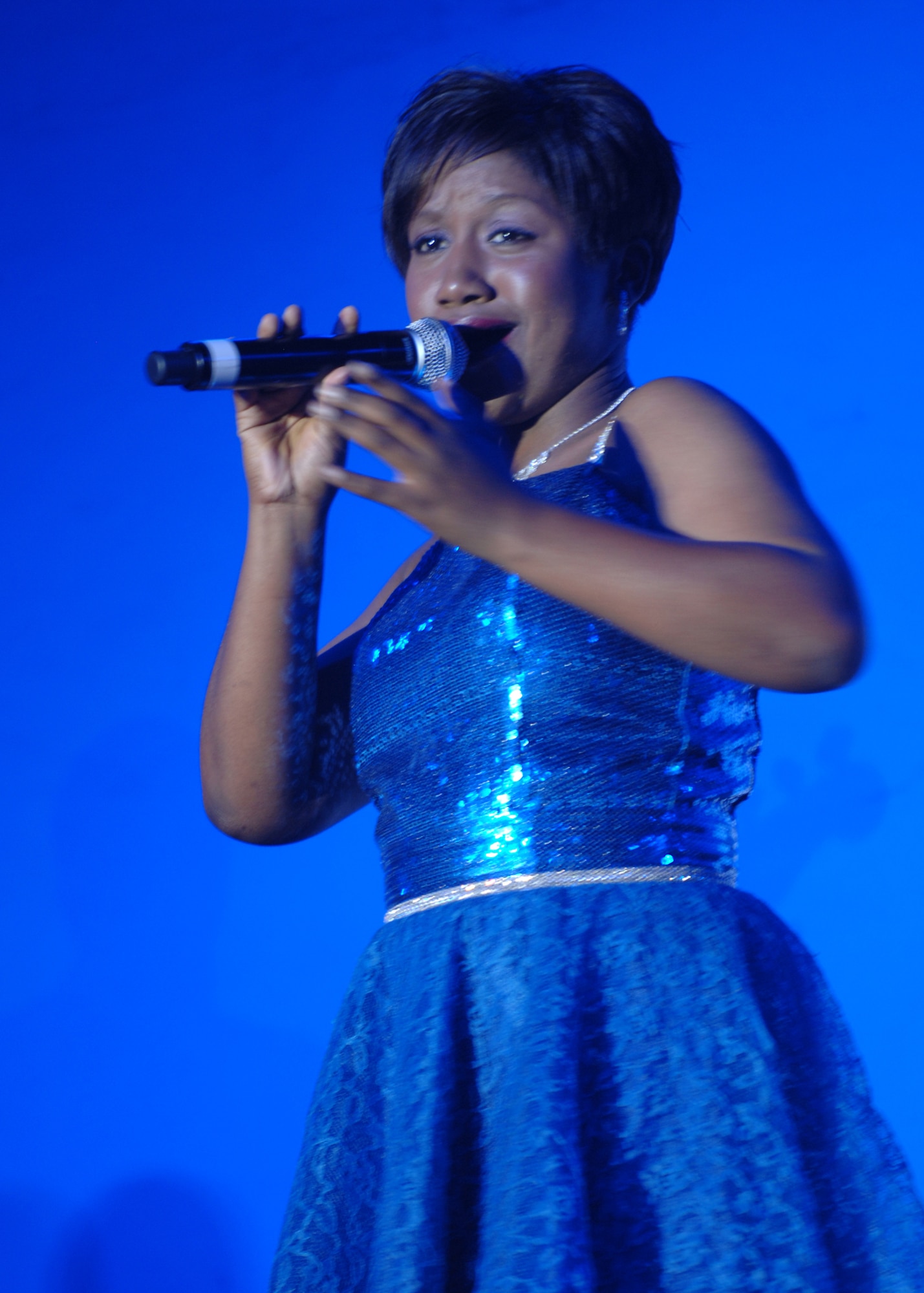 Airman 1st Class Alice Lewis, Tops in Blue vocalist, sings a song during the Tops in Blue performance Sept. 23. Airman Lewis is one of 14 vocalists in the 30-member performance group. (U.S. Air Force photo by Staff Sgt. Jeff Nevison)