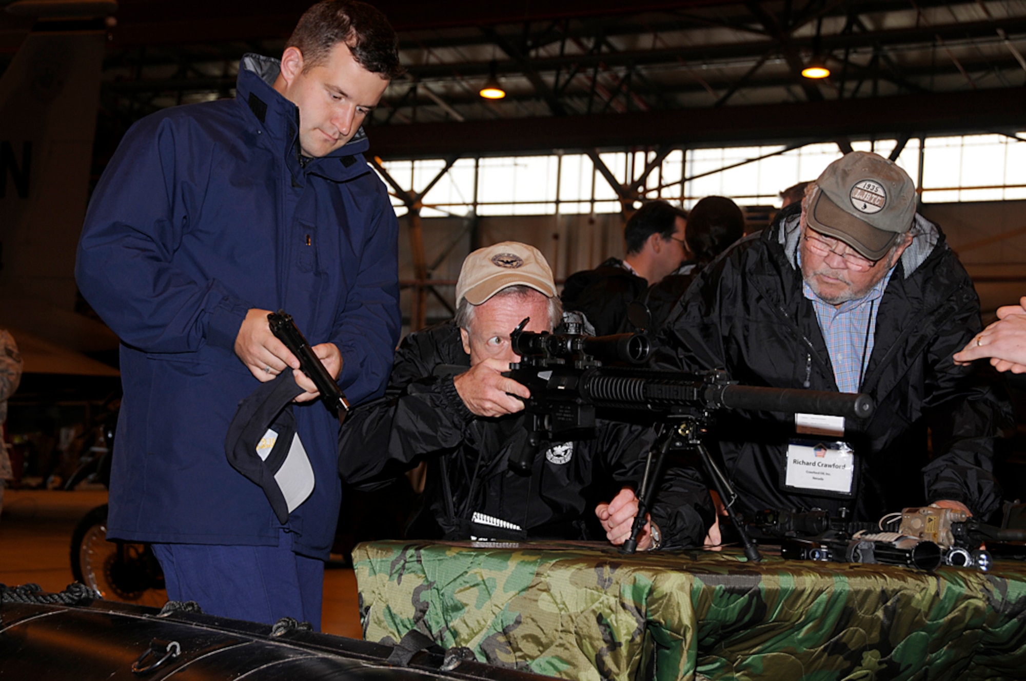 Attendees of the Joint Civilian Orientation Conference look at various weapons used by the 322nd Special Tactics Squadron at RAF Lakenheath, England, Sept. 23. The attendees were able to see the different equipment utilized by the STS and get an understanding of what they bring to the mission of the United States Air Force. (U.S. Air Force photo by Senior Airman Brian J. Ellis)