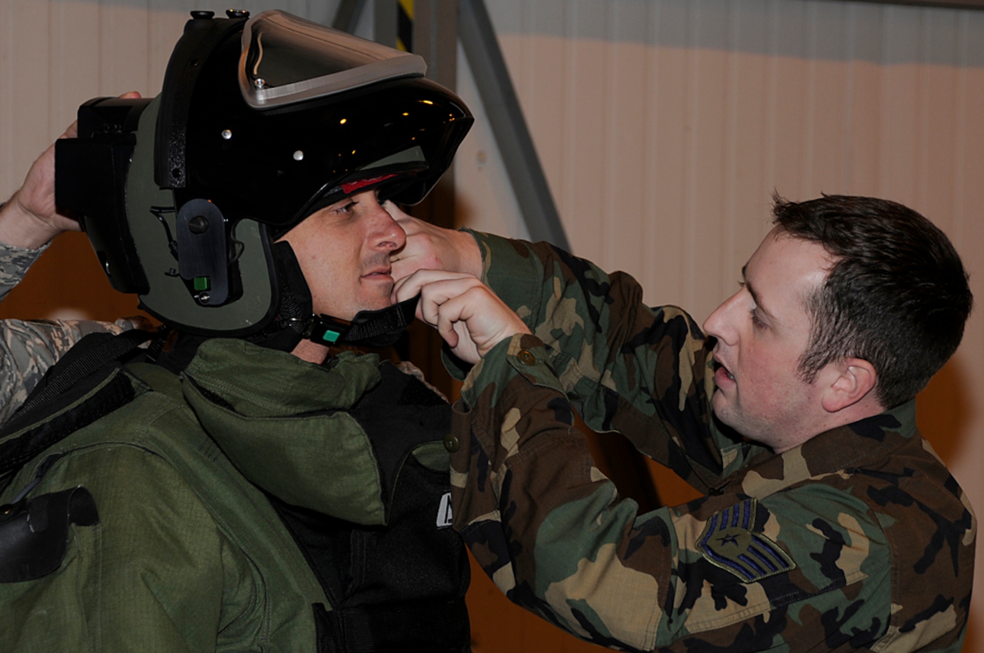 Mr. Sky Dayton, President and Founder of Earthlink, is assisted with putting on a helmet of a bomb disposal suit during the Joint Civilian Orientation Conference at RAF Lakenheath, England Sept. 23. Mr. Dayton was one of many distinguished visitors touring the European Command to see what capabilities they bring to the global war on terror. (U.S. Air Force photo by Senior Airman Brian J. Ellis)