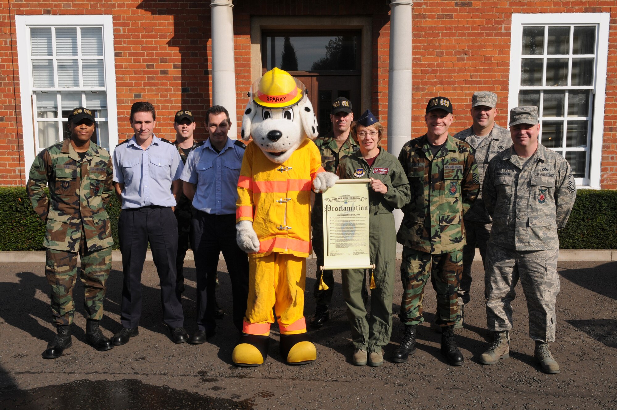 Col. Eden J. Murrie, 100th Air Refueling Wing commander, along with Sparky the Fire Dog, holds the signed proclamation kicking off fire prevention week Sept. 19, 2008, at RAF Mildenhall, England. Fire Prevention Week will provide a chance to get helpful tips and information and participate in demonstrations to show how to be safe in an event of a fire. (U.S. Air Force photo by Staff Sergeant Jerry Fleshman)