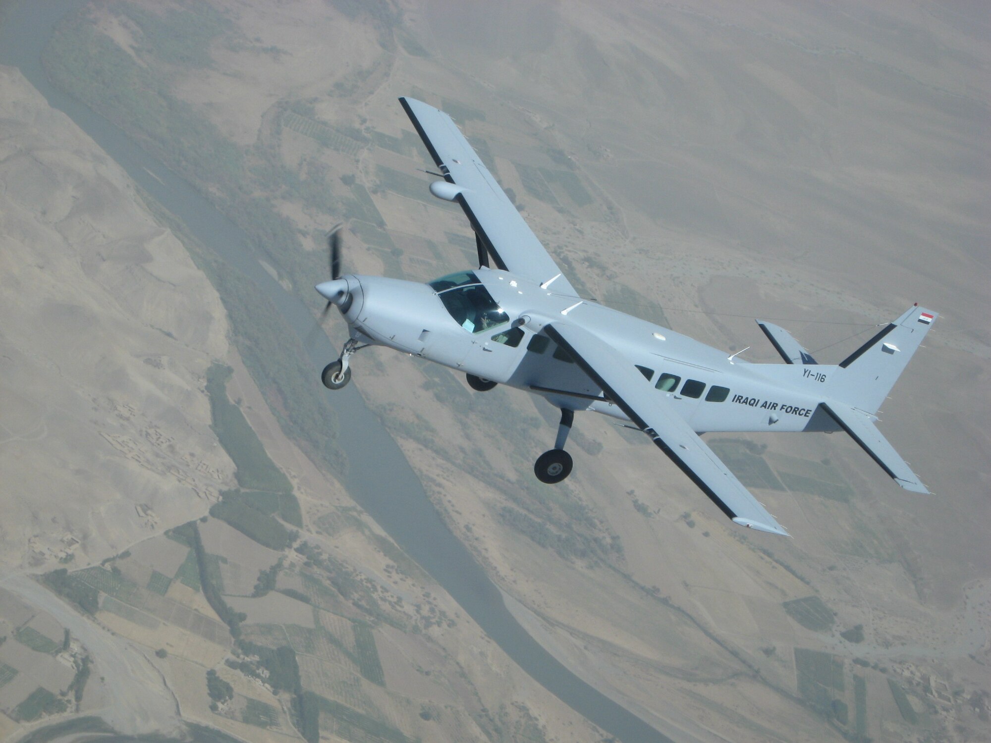 KIRKUK REGIONAL AIR BASE, Iraq -- A Cessna 208 Caravan assigned to the Iraqi air force Flying Training Wing flies over Northern Iraq during a recent training mission.  Second Lt. Hassan, Iraqi air force student pilot and Lt. Col. Scott Voskovitch, 52nd Expeditionary Flying Training Squadron instructor pilot, flew a similar aircraft while eclipsing the 3,000th flying training hour here Sept 23.  The 3,000-hour mark was accomplished at a much faster pace than the previous milestone of 2,000 hours. It took 91 days to increase from 1,000 hours to 2,000, but only 72 days more to reach the latest milestone.  (U.S. Air Force photo/Lt. Col. Scott Voskovitch) 