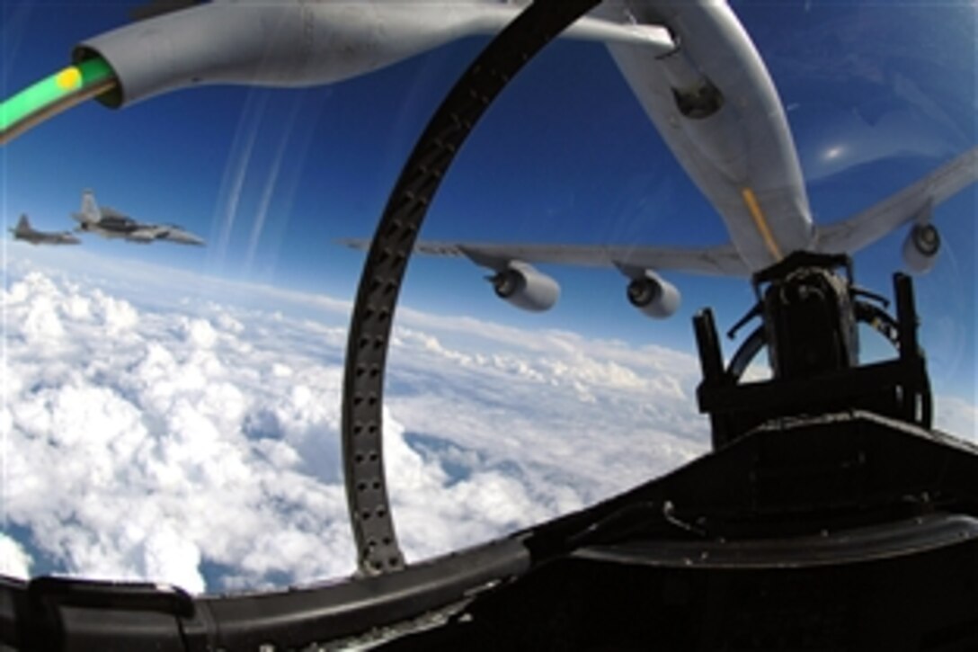 The refueling boom from a KC-135 Stratotanker arches over an F-15 Eagle as it refuels the aircraft over eastern Florida, Sept. 20, 2008. An F-22 Raptor and another F-15 Eagle from Tyndall Air Force Base, Fla., are participating in the training mission with the Mississippi Air National Guard. 