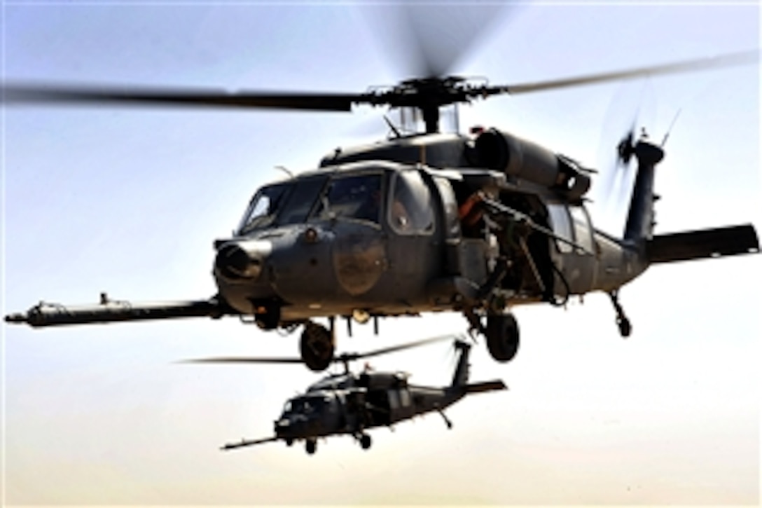 Two U.S. Air Force HH-60G Pave Hawk helicopters fly over an area during a training exercise, Iraq, Sept. 19, 2008. The crew and helicopters are assigned to the 66th Expeditionary Rescue Squadron.