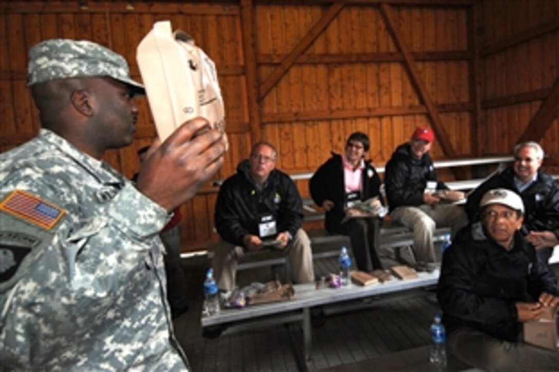 U.S. Army Sgt. 1st Class Michael Williams explains how to prepare Meals Ready to Eat to participants attending the 76th Joint Civilian Orientation Conference during a lunch break at Grafenwoehr Army Air Field, Germany, on Sept. 24, 2008. 