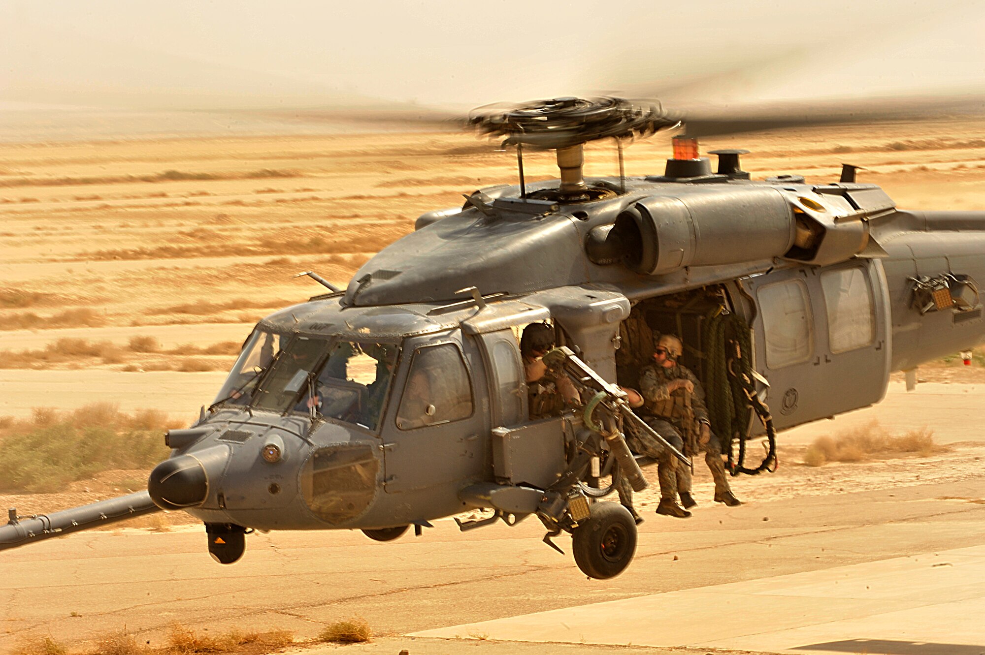 U.S. Air Force Pararescuemen from the 66th Expeditionary Rescue Squadron fly aboard an HH-60G Pave Hawk during an operational training mission in Iraq.(Photo by Staff Sgt. Aaron Allmon)

