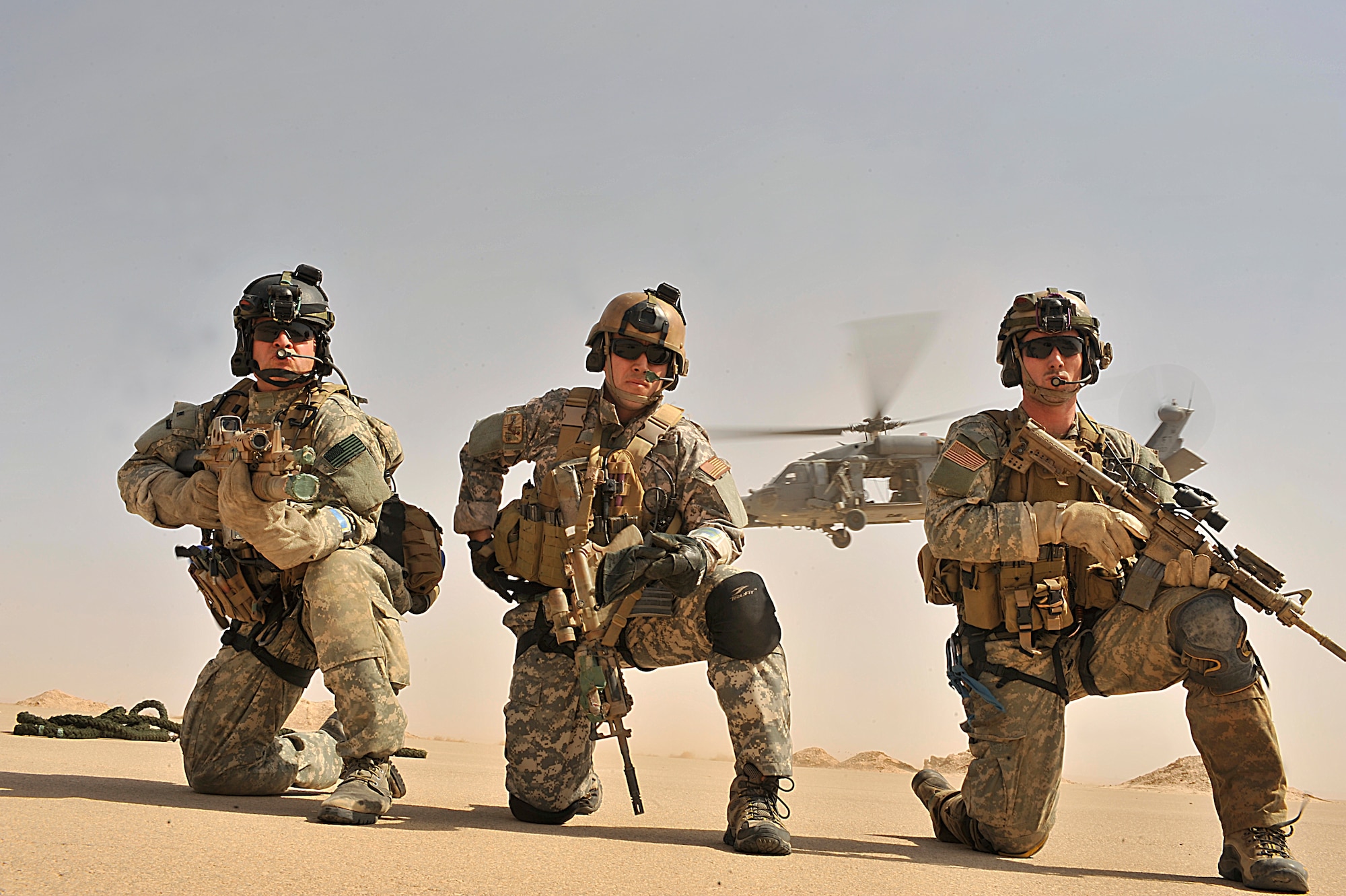 U.S. Air Force Pararescuemen Senior Airman Corey Farr(right) and  Staff Sgt. Jeremy Diola(center) and Senior Master Sgt. Michael Fleming of the 66th Expeditionary Rescue Squadron pull security after exiting an HH-60G Pave Hawk during an operational training exercise in Iraq. (U.S. Air Force photo by Staff Sgt. Aaron Allmon) 
 
