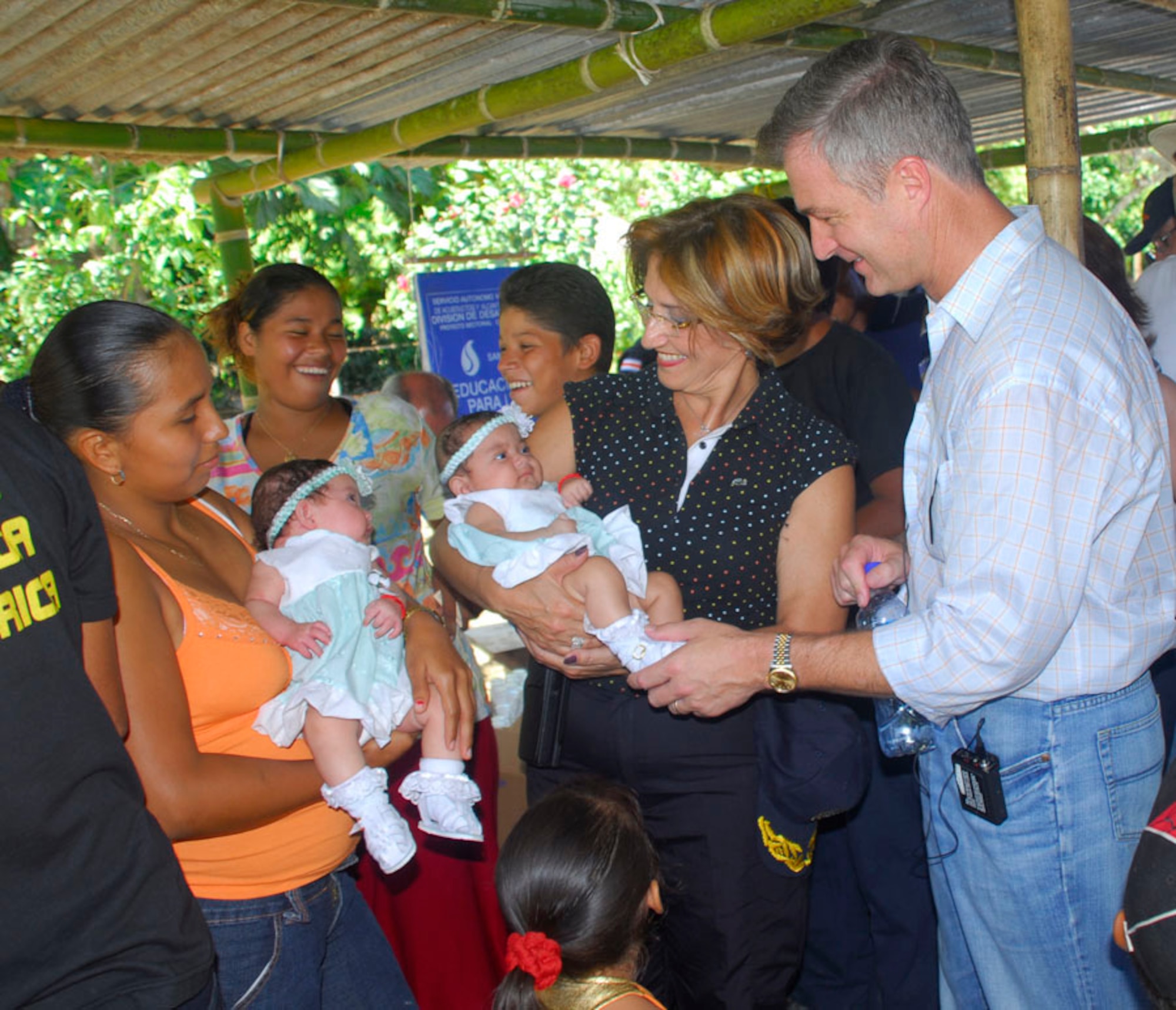 Janina Del Verchio, Costa Rica Minister of Public Security, and Peter Cianchette, U.S. Ambassador to Costa Rica, talk with a family who  received help from the medical readiness exercise in La Pena, Costa Rica. The family, who recently had twins, had received help from the Costa Rica Department of Safety when the twins were born had come back to say thank you and participate in the MEDRETE.(U.S. Air Force photo by Staff Sgt. Joel Mease)
