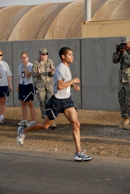 SOUTHWEST ASIA -- Mike Bowman gets cheered on from the sidelines as he finishes first place in the 13.1-mile "half-marathon" held at the 380th Air Expeditionary Wing today with a time of 1:26:10. The winner is a Boston Marathon qualifier and hopes to qualify for other named marathons as well. This event is an official extension of the U.S. Air Force Marathon that was held at Wright-Patterson Air Force Base, Ohio, Sept. 20. Extensions of the marathon allow deployed Airmen to compete as long as they are registered and the event follows official rules. Extensions must be held within 10 days of the actual marathon. (U.S. Air Force photo/Tech. Sgt. Denise Johnson)(released)