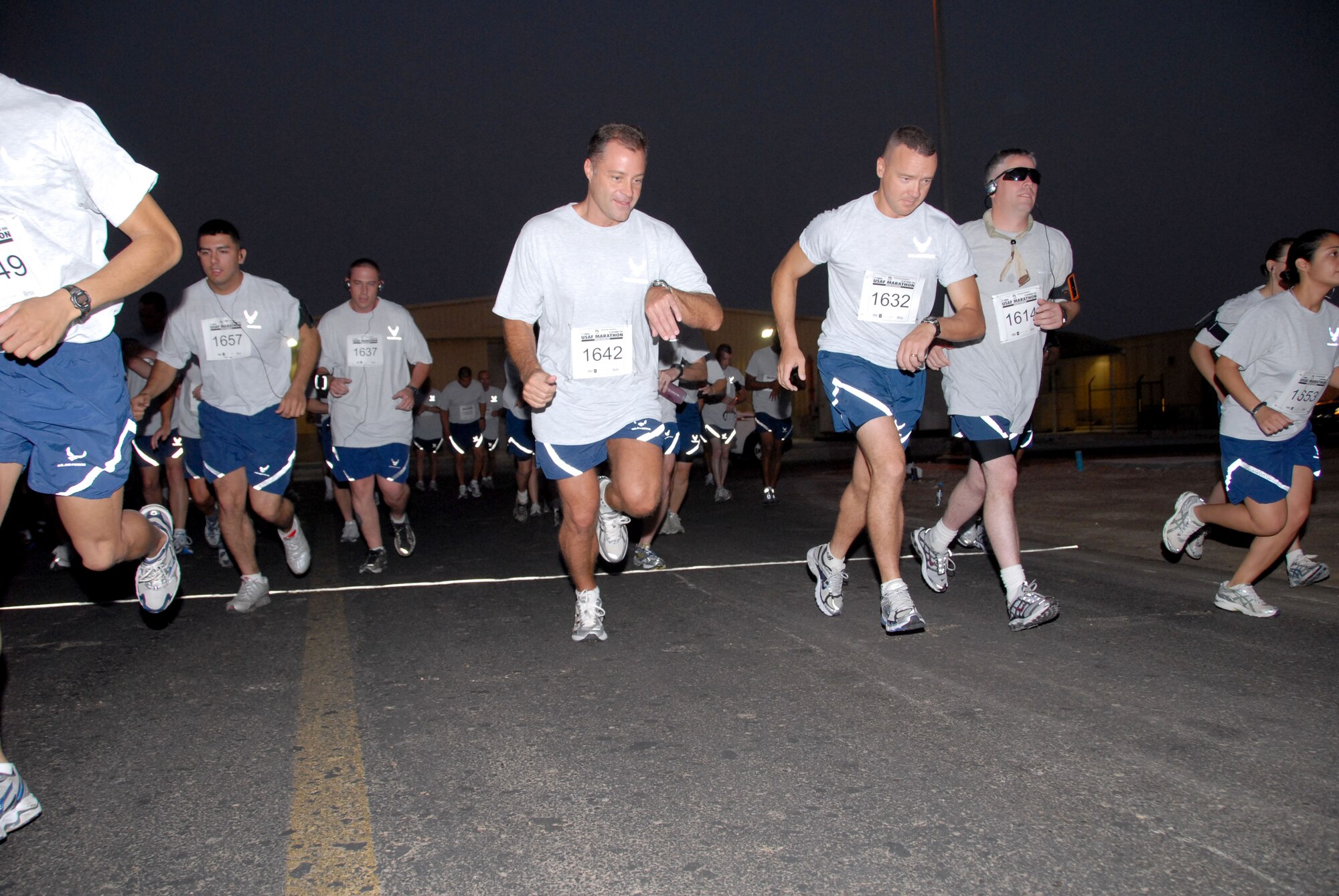 SOUTHWEST ASIA -- Runners start their watches for the 13.1-mile "half-marathon" held at the 380th Air Expeditionary Wing here today. The event is an official extension of the U.S. Air Force Marathon that was held at Wright-Patterson Air Force Base, Ohio, Sept. 20. Extensions of the marathon allow deployed Airmen to compete as long as they are registered and the event follows official rules. Extensions must be held within 10 days of the actual marathon. (U.S. Air Force photo/Tech. Sgt. Denise Johnson)(released)