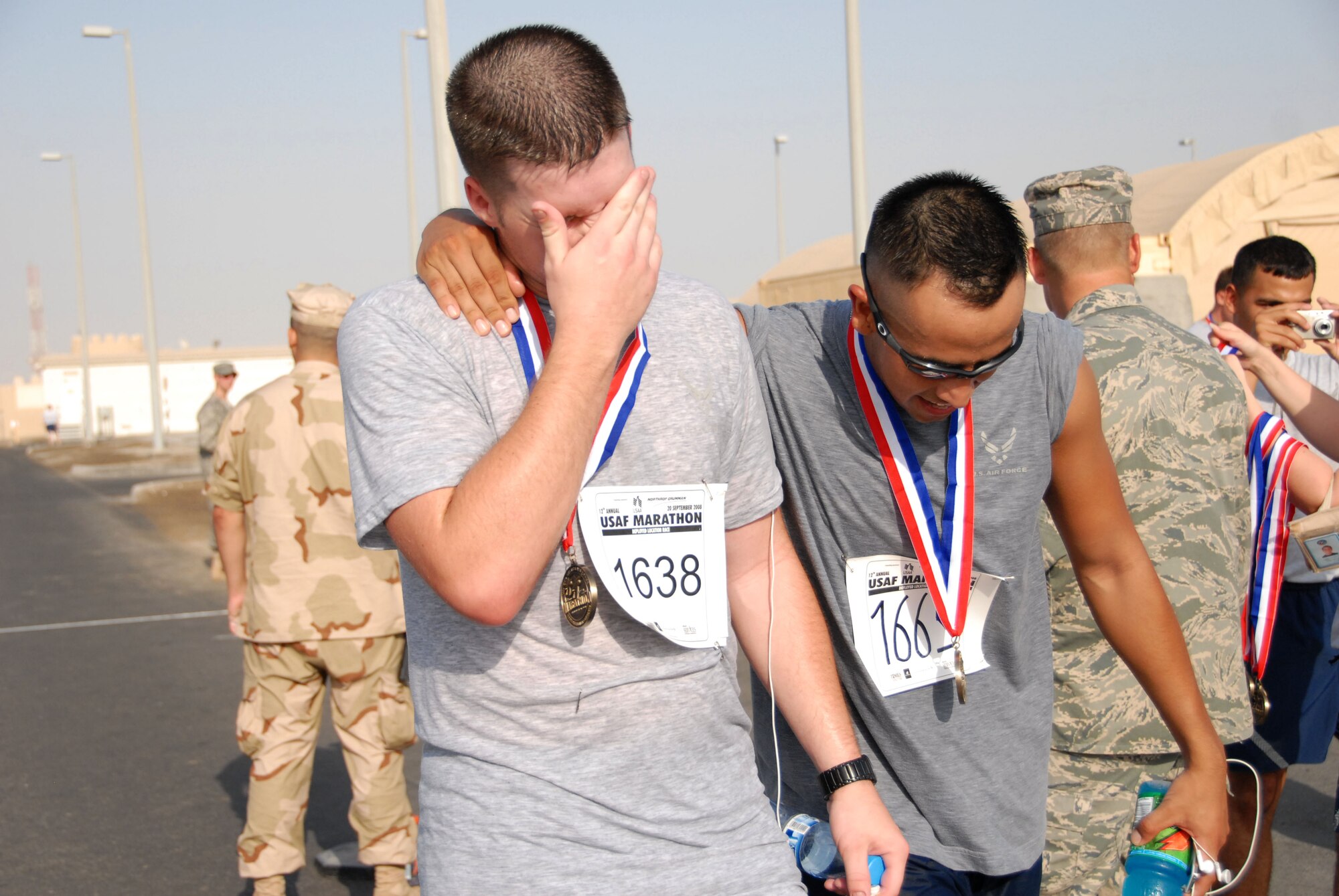 SOUTHWEST ASIA -- Stephen Biddinger (left) and Nathaniel Gonzales finish the 13.1-mile "half-marathon" held at the 380th Air Expeditionary Wing here today with a time of 2:08:25 and 2:08:24 respectively. The event is an official extension of the U.S. Air Force Marathon that was held at Wright-Patterson Air Force Base, Ohio, Sept. 20. Extensions of the marathon allow deployed Airmen to compete as long as they are registered and the event follows official rules. Extensions must be held within 10 days of the actual marathon. (U.S. Air Force photo/Tech. Sgt. Denise Johnson)(released)