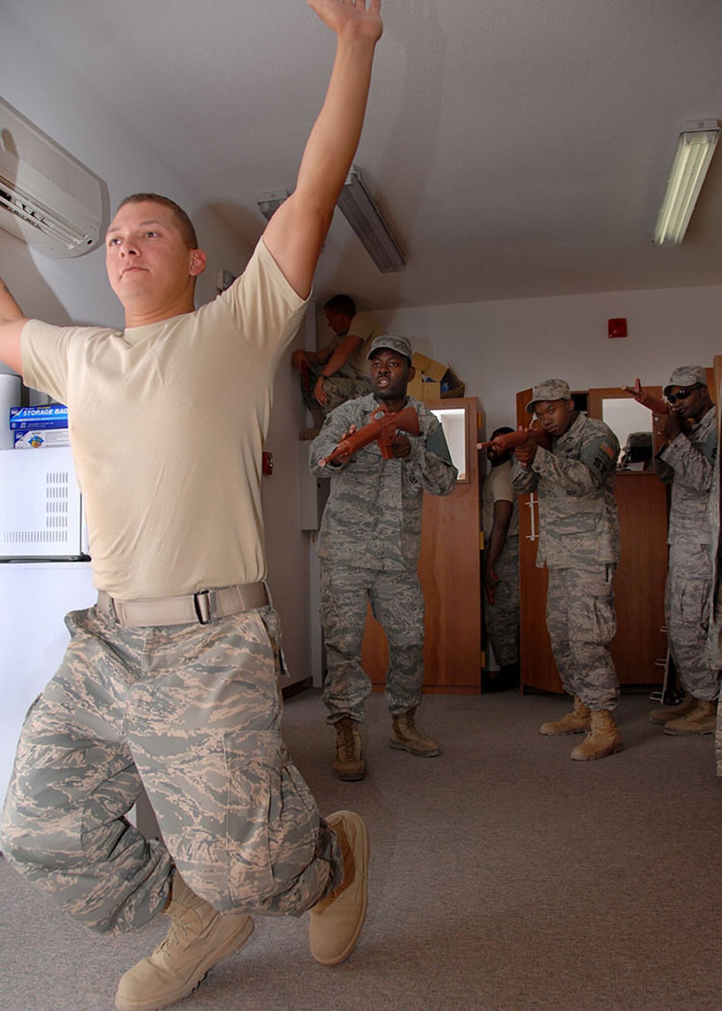 SOUTHWEST ASIA -- Senior Airman Alexander Williams, 380th Expeditionary Security Forces Squadron journeyman, challenges Airman 1st Class Robert Sosa of the fire team during a room-clearing exercise here Friday. The Airmen are performing fire-team movement training during their formal monthly training to keep security forces' skills sharp for any real-world situtations. (U.S. Air Force photo/Tech. Sgt. Denise Johnson)(released)