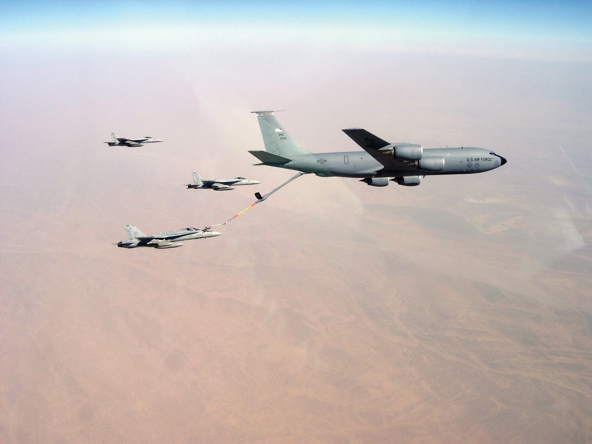 An F/A-18C Hornet assigned to Strike Fighter Squadron (VFA) 113 refuels from a KC-135R Stratotanker while two F/A-18E Super Hornets assigned to VFA 115 fly alongside during flight operations above Afghanistan Aug. 28, 2008. VFA 113 and VFA 115 are attached to Carrier Air Wing 14 aboard the Nimitz-class aircraft carrier USS Ronald Reagan (CVN 76). KC-135 aircraft from the 340th Expeditionary Air Refueling Squadron provide critical air refueling capability to air assets on the USS Ronald Reagan. (DoD photo by Cmdr. Erik Etz, U.S. Navy)