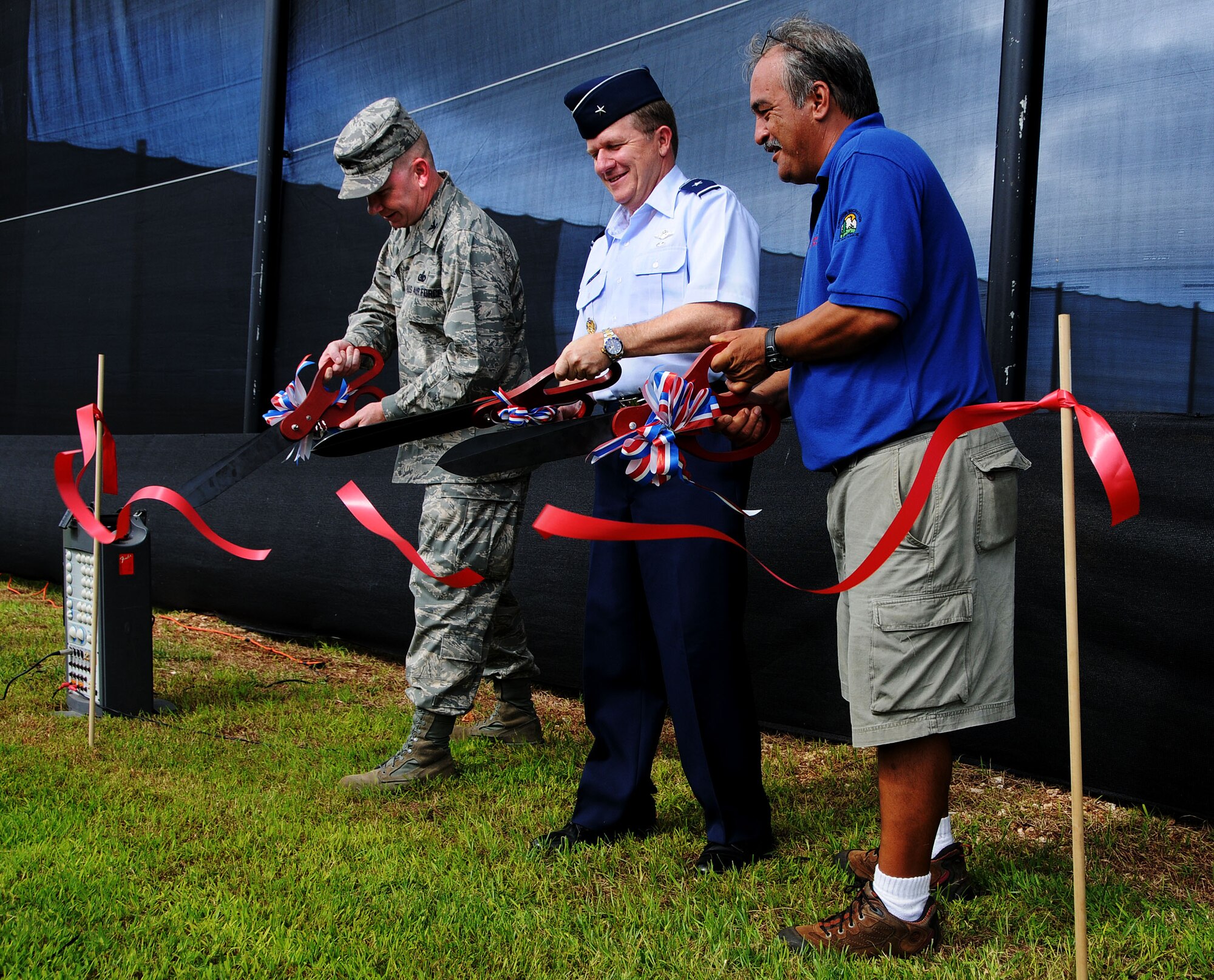 ANDERSEN AIR FORCE BASE, Guam - Colonel Mark Talley, Brig. Gen. Phil Ruhlman, and Ray Stiers cut the ribbon at the grand opening ceremony of the new paintball complex here Sept. 26. Construction on the facility began in January. (U.S. Air Force photo by Airman 1st Class Courtney Witt)