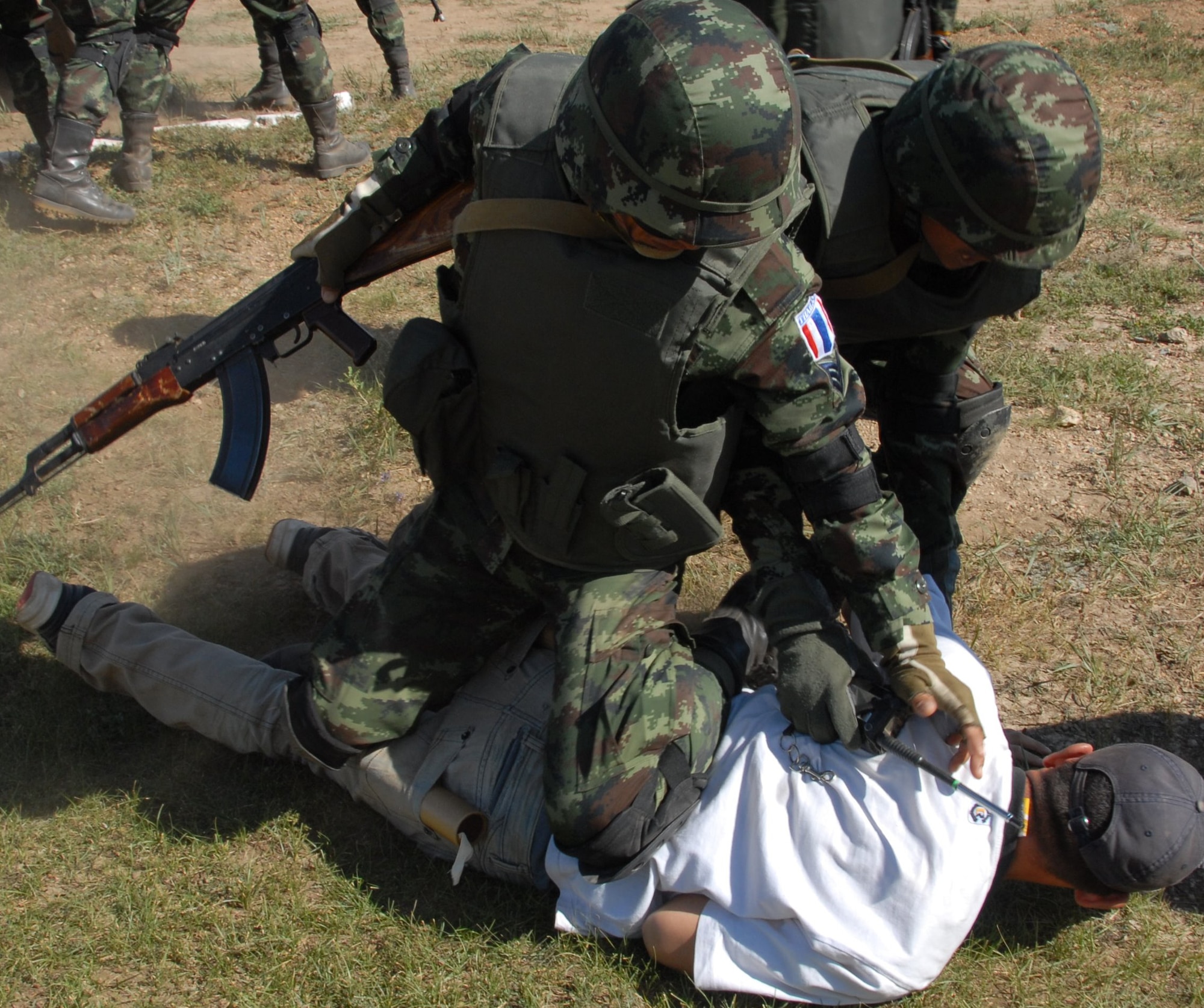 Soldiers from Thailand army rehearse peace keeping exercises with Mongolian role players during the field training exercise Khaan Quest 2008, a United Nations multinational peace support exercise in Mongolia at Camp Five Hills Training Center near Ulaan Baatar. Alaska Air National Guard photo by MSgt Jules Barklow.
