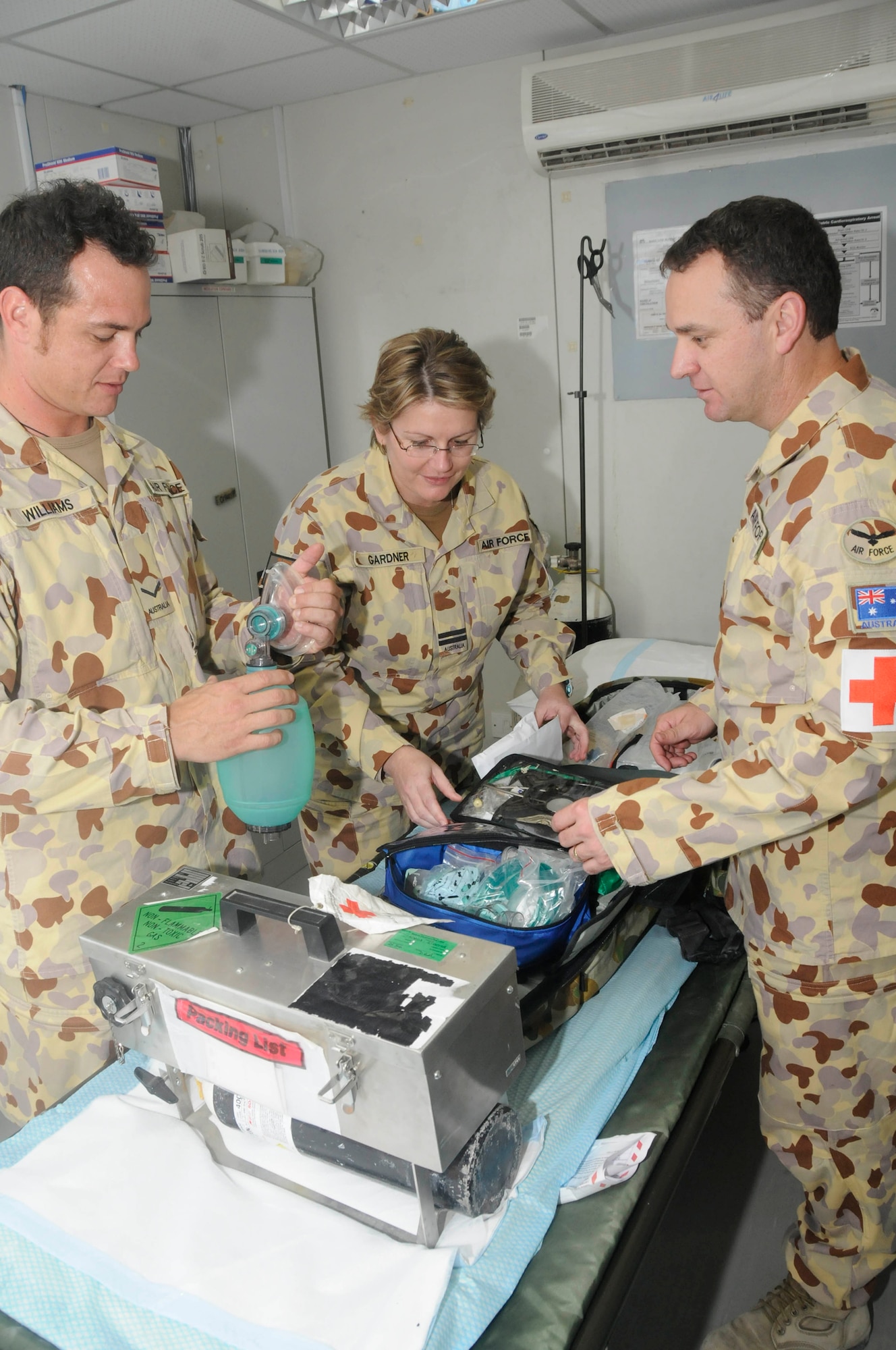 Leading Air Craftsman Brendan Williams, medical assistant, Flight Lieutenant Amanda Gardner, medical officer, and Flying Officer Michael Babic, nursing officer, all assigned to the Expeditionary Health Facility Task Group 633.4, perform a routine check on the emergency response pack equipment to ensure all components are working and not expired Sept. 26, 2008, at an undisclosed air base in Southwest Asia. The EHF members are responsible for providing primary medical and aviation medical support to all Australian coalition forces here. Craftsman Williams, a native of Newcastle Australia, is deployed from Royal Australian Air Force Base Williamtown. Lieutenant Gardner, a native of Newcastle, Australia, is deployed from RAAFB Amberley. Officer Babic, a native of Newcastle, Australia, is deployed from RAAFB Williamtown. They are all supporting Operations Iraqi Freedom, Enduring Freedom and Joint Task Force-Horn of Africa. (U.S. Air Force photo by Staff Sgt. Darnell T. Cannady/Released)